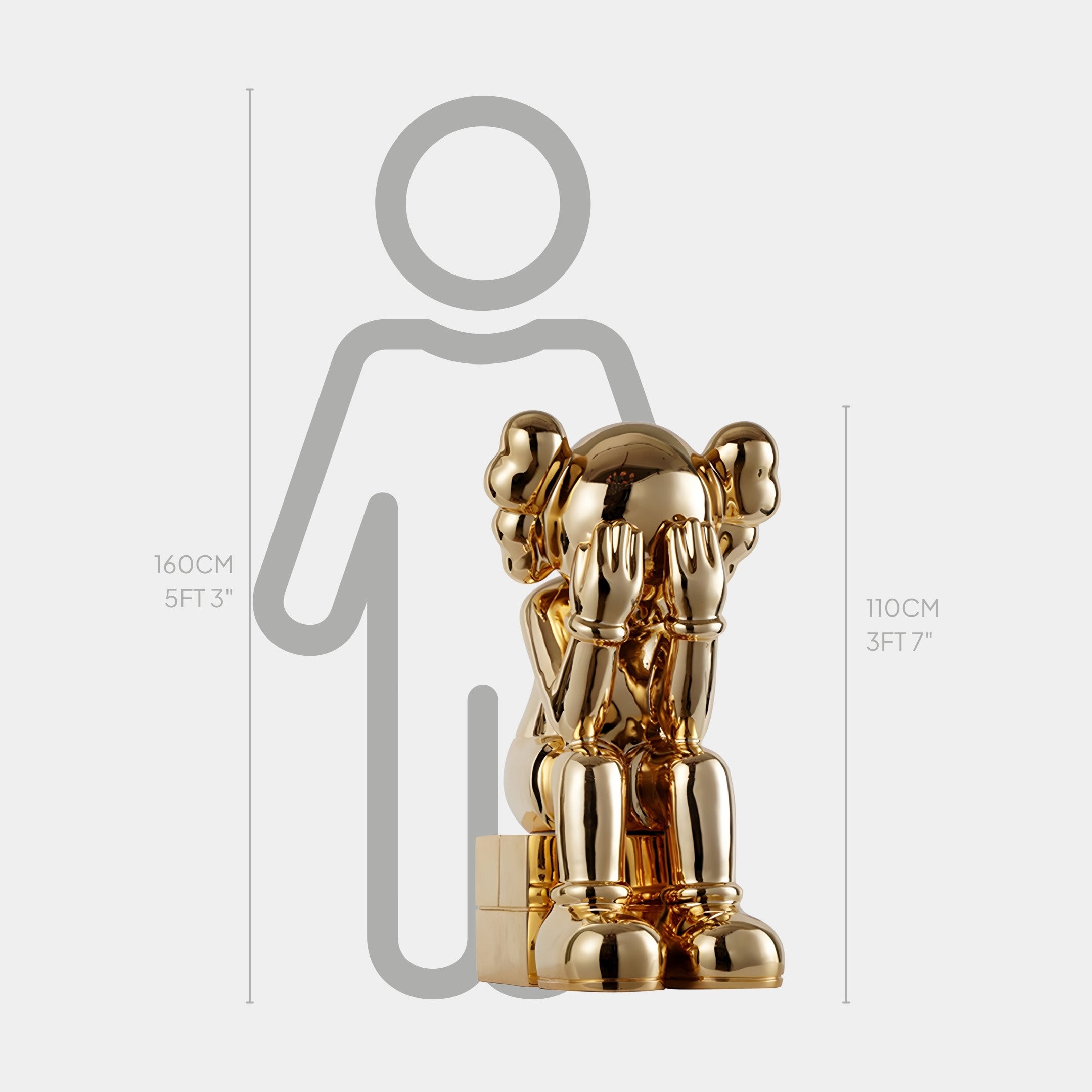 The Antique Gold Iconify Melancholy Sitting Sculpture by Giant Sculptures is a luxury decor piece, featuring a cartoon-like seated figure with its face covered. At 110 cm (3 ft 7 in), it stands next to a height outline of 160 cm (5 ft 3 in), evoking feelings of melancholy.