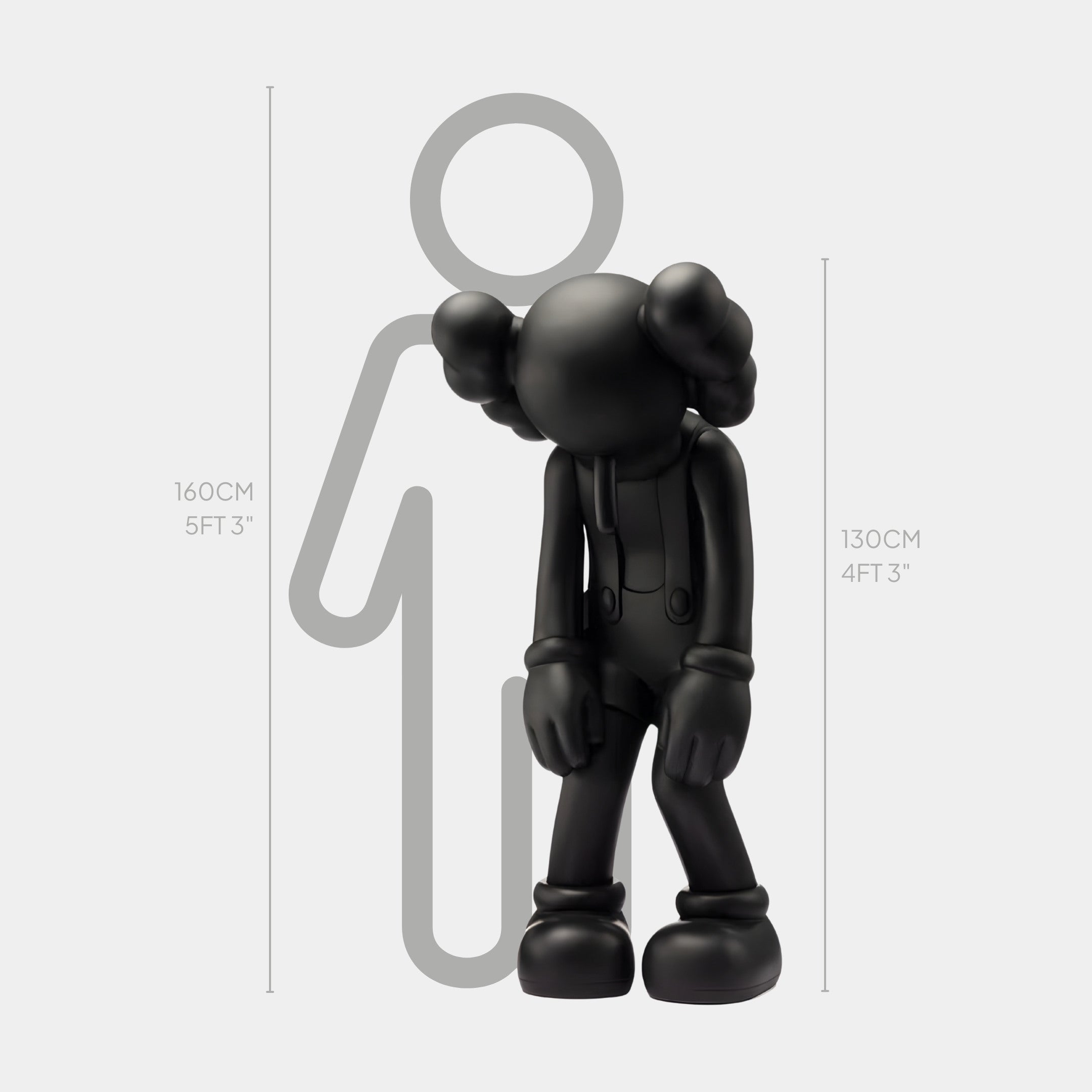 The Midnight Black Iconify Burden Sculpture by Giant Sculptures is a cartoon-like figure with crossed-out eyes and oversized gloves, standing 130 cm (4 ft 3 in) tall next to a 160 cm (5 ft 3 in) silhouette for height comparison.