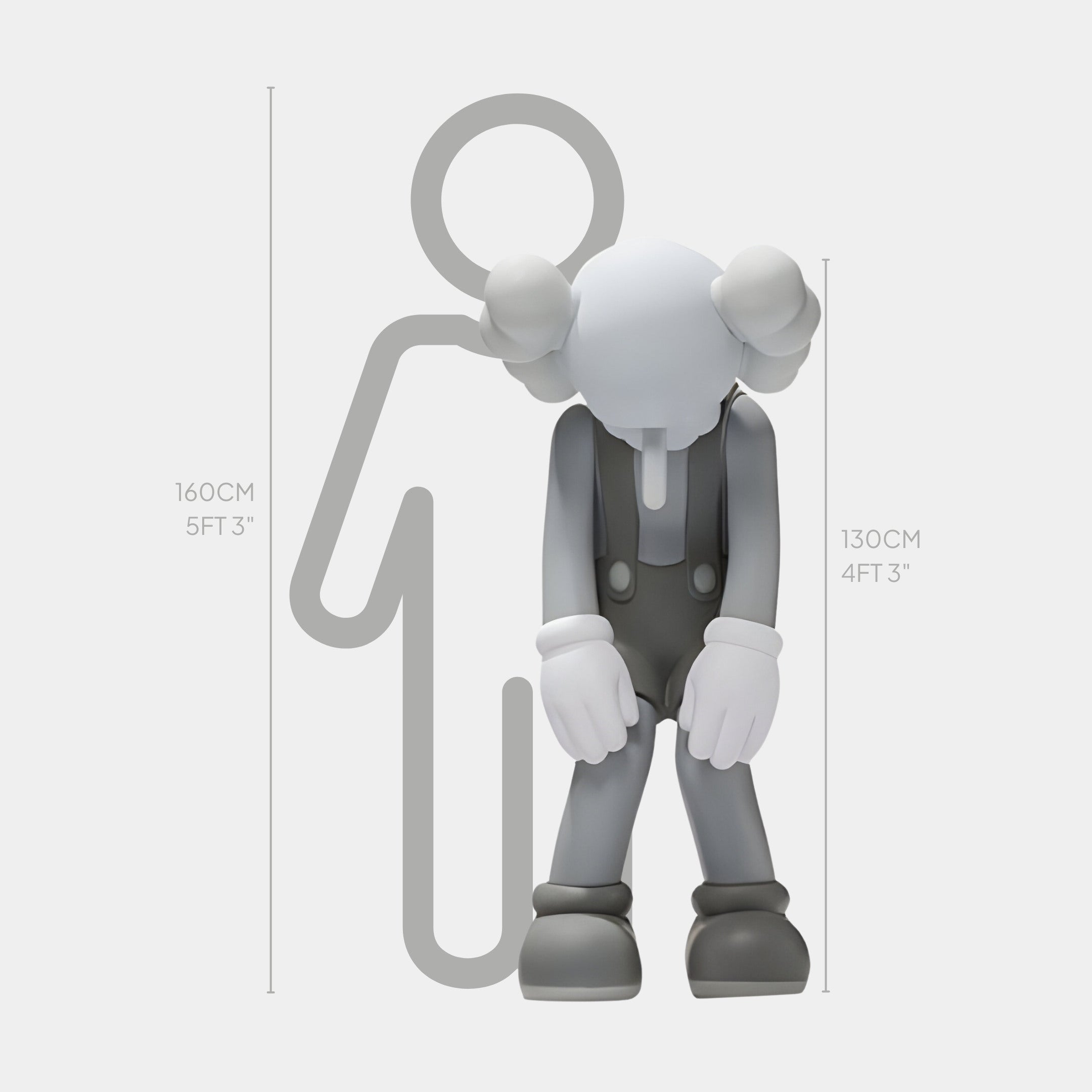 The Giant Sculptures Steel Grey Iconify Burden Sculpture - 130cm, featuring a character in overalls with large gloves in a bowing pose, stands before a silhouetted figure for scale, highlighting its modern aesthetic against the silhouettes height of 160 cm (5 ft 3 in).