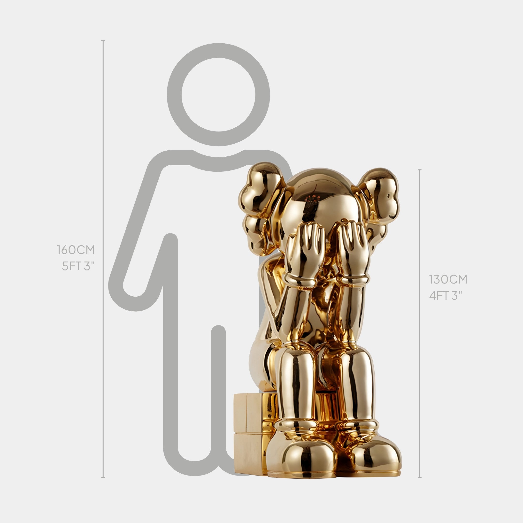 The Antique Gold Iconify Melancholy Sitting Sculpture by Giant Sculptures is a 130 cm luxury decor piece in modern artistry, resembling a seated cartoon figure with hands covering its face, set against a diagram with a 160 cm human for scale.