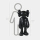 The Giant Sculptures Midnight Black Iconify Standing Sculpture, a 130cm (4ft 3in) cartoon-style black figure with distinct ears, stands beside a 160cm (5ft 3in) grey silhouette, seamlessly blending into modern interiors with its contemporary design.