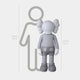 The Slay Grey Iconify Standing Sculpture by Giant Sculptures features a slate grey cartoon character with Xs for eyes, standing 130 cm (4 ft 3 in) tall next to a 160 cm (5 ft 3 in) human figure outline, ideal for modern interiors.