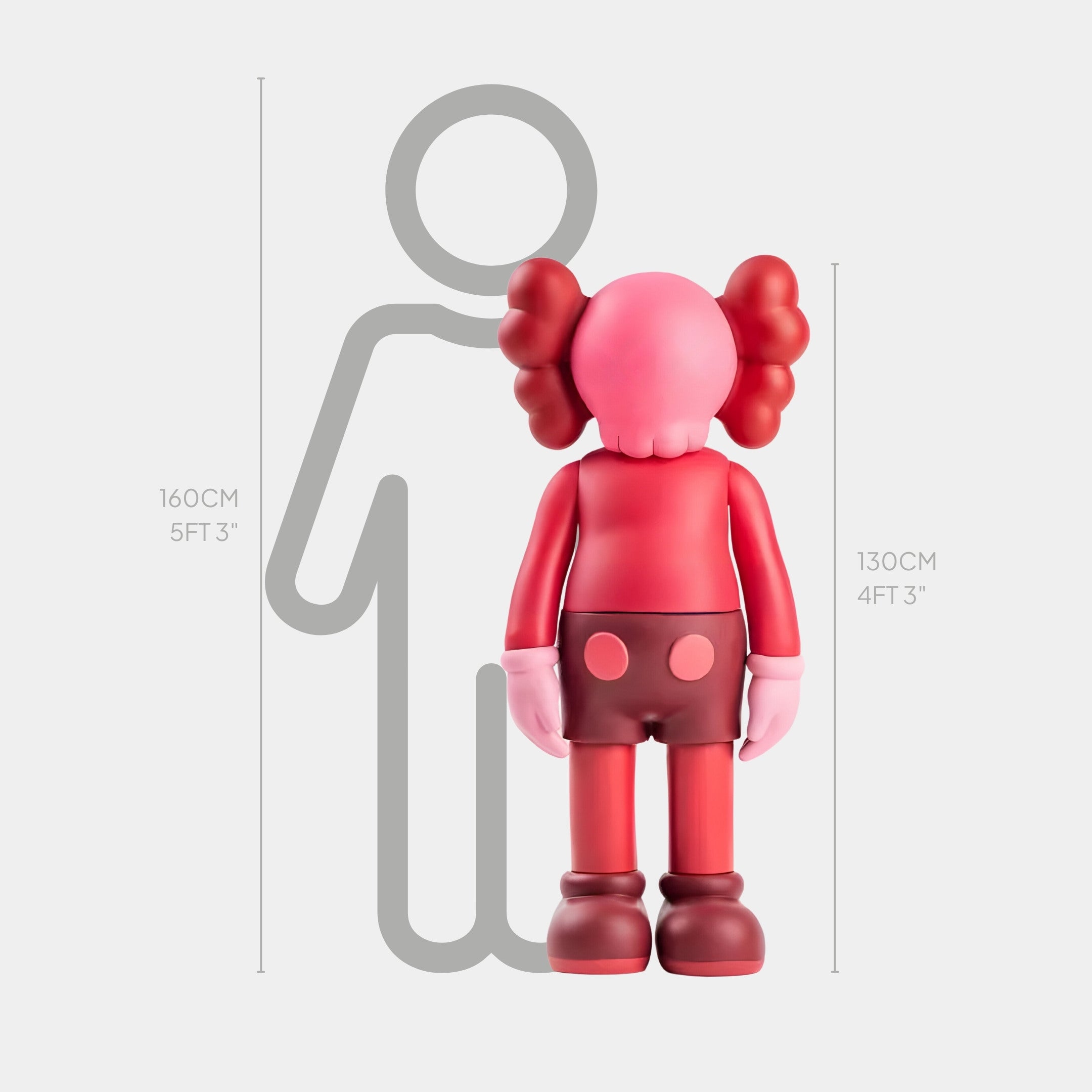 A red character with cloud-like hair, reflecting a modern aesthetic, stands beside a gray outline of a person. The Giant Sculptures Blush Ruby Iconify Standing Sculpture measures 130 cm (4 ft 3 in), while the human outline is labeled at 160 cm (5 ft 3 in), exuding contemporary sophistication.