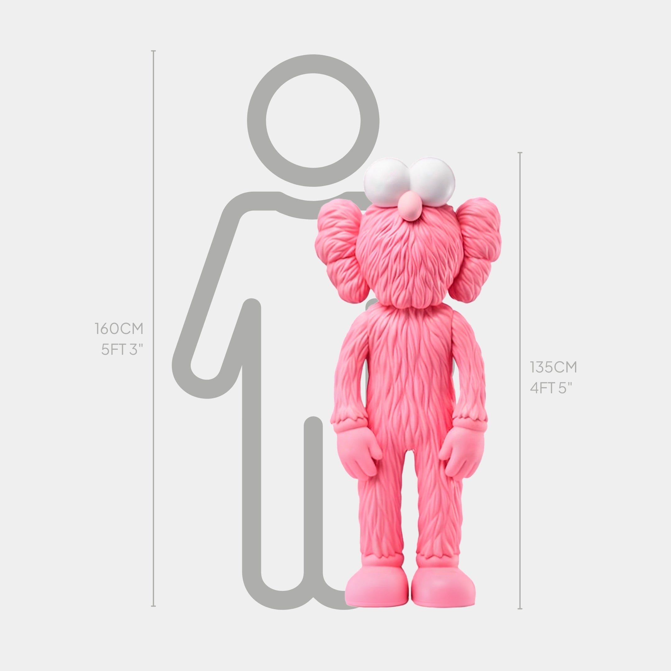 An image features the Petal Pink Iconify Furry Sculpture by Giant Sculptures, a 135 cm tall character with cartoon eyes and a round nose, next to a 160 cm gray human outline. Ideal for contemporary interiors or luxury boutiques.