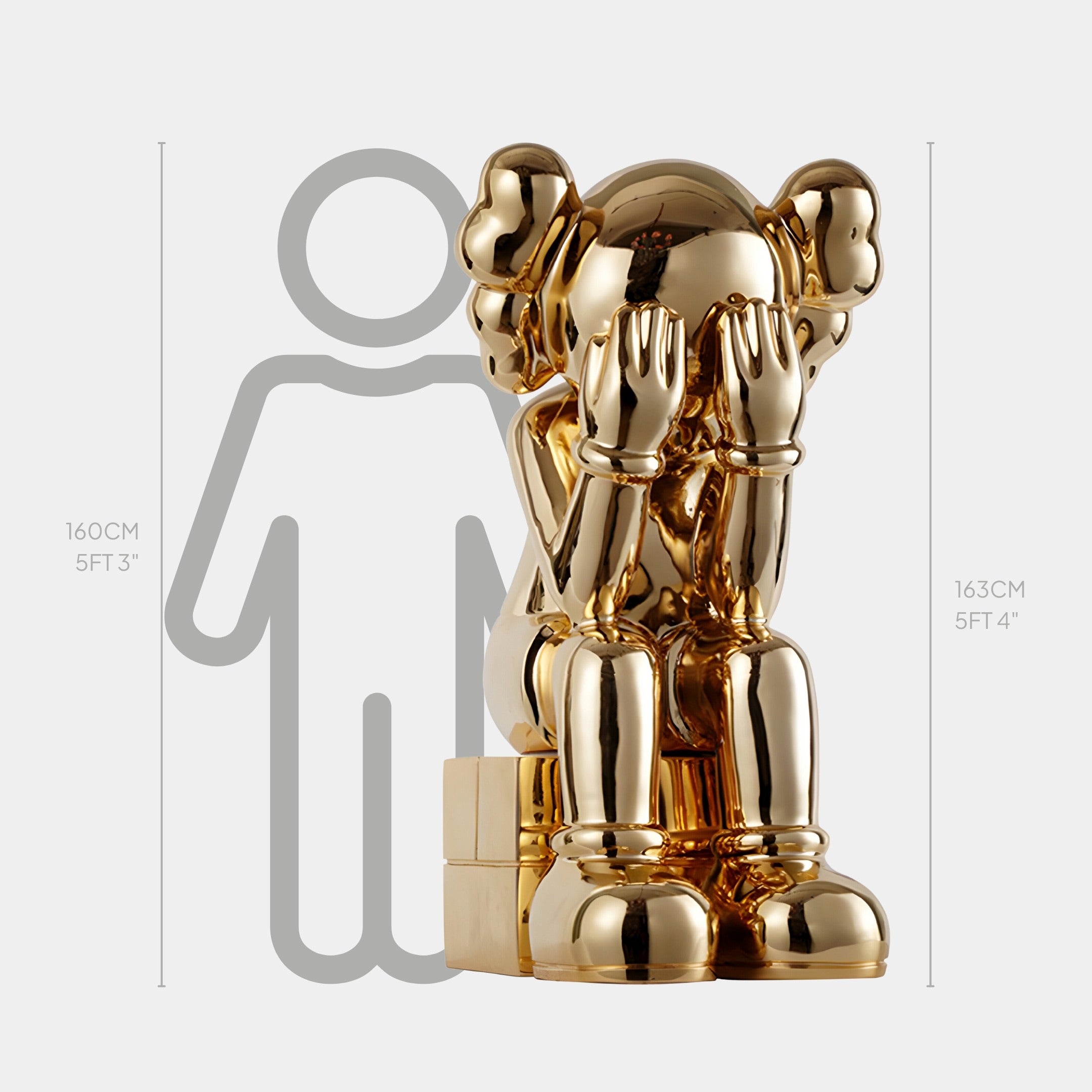 The Antique Gold Iconify Melancholy Sitting Sculpture by Giant Sculptures, at 163 cm, showcases emotive artistry with its shiny gold finish and cartoon-like character. Its scale outline highlights heights of 160 cm and 163 cm—perfect for luxury interiors.