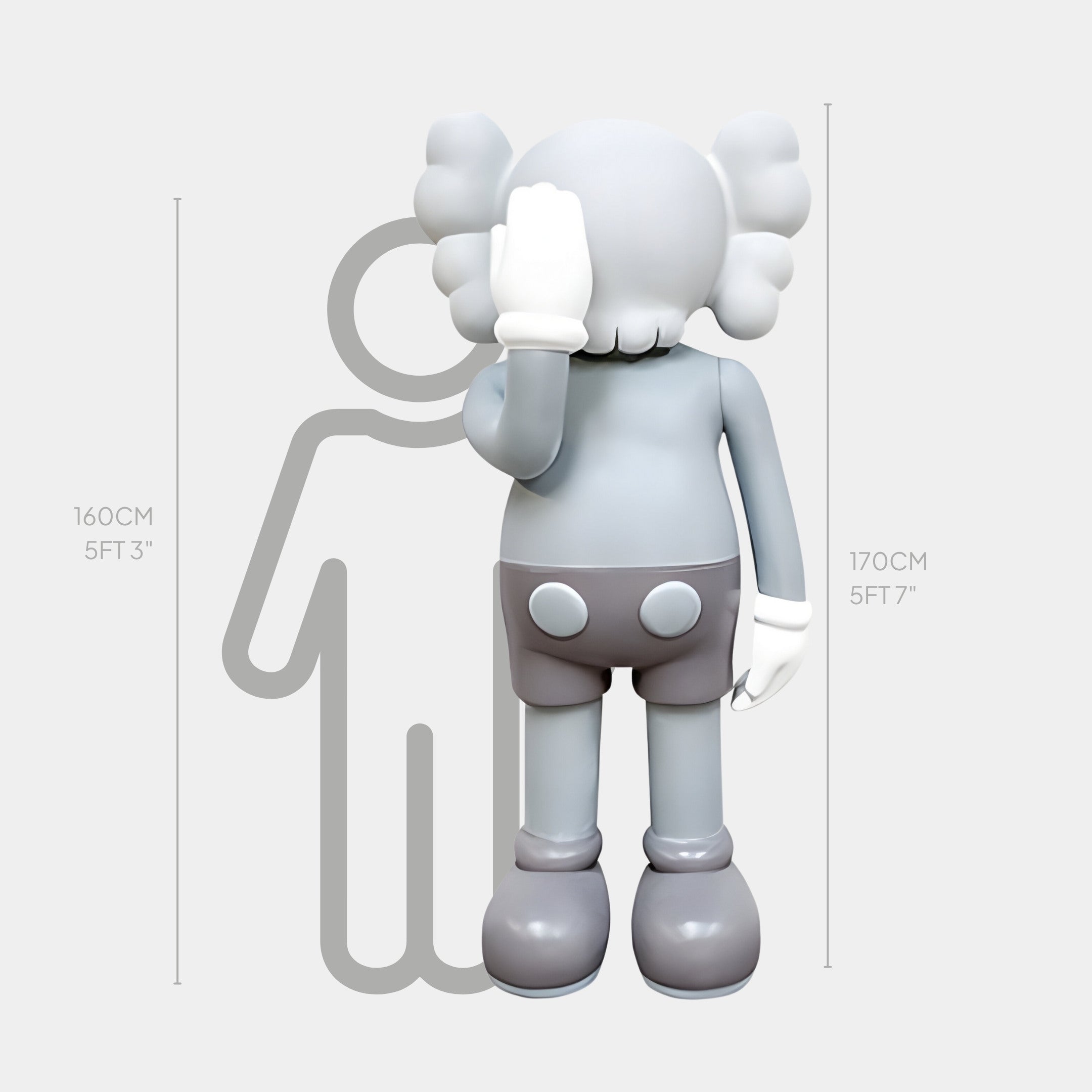 The Soft Grey Iconify V Dance Sculpture by Giant Sculptures features a cartoon-like statue with large shoes, gloves, and crossed-out eyes, standing at 170 cm in front of a height chart silhouette.