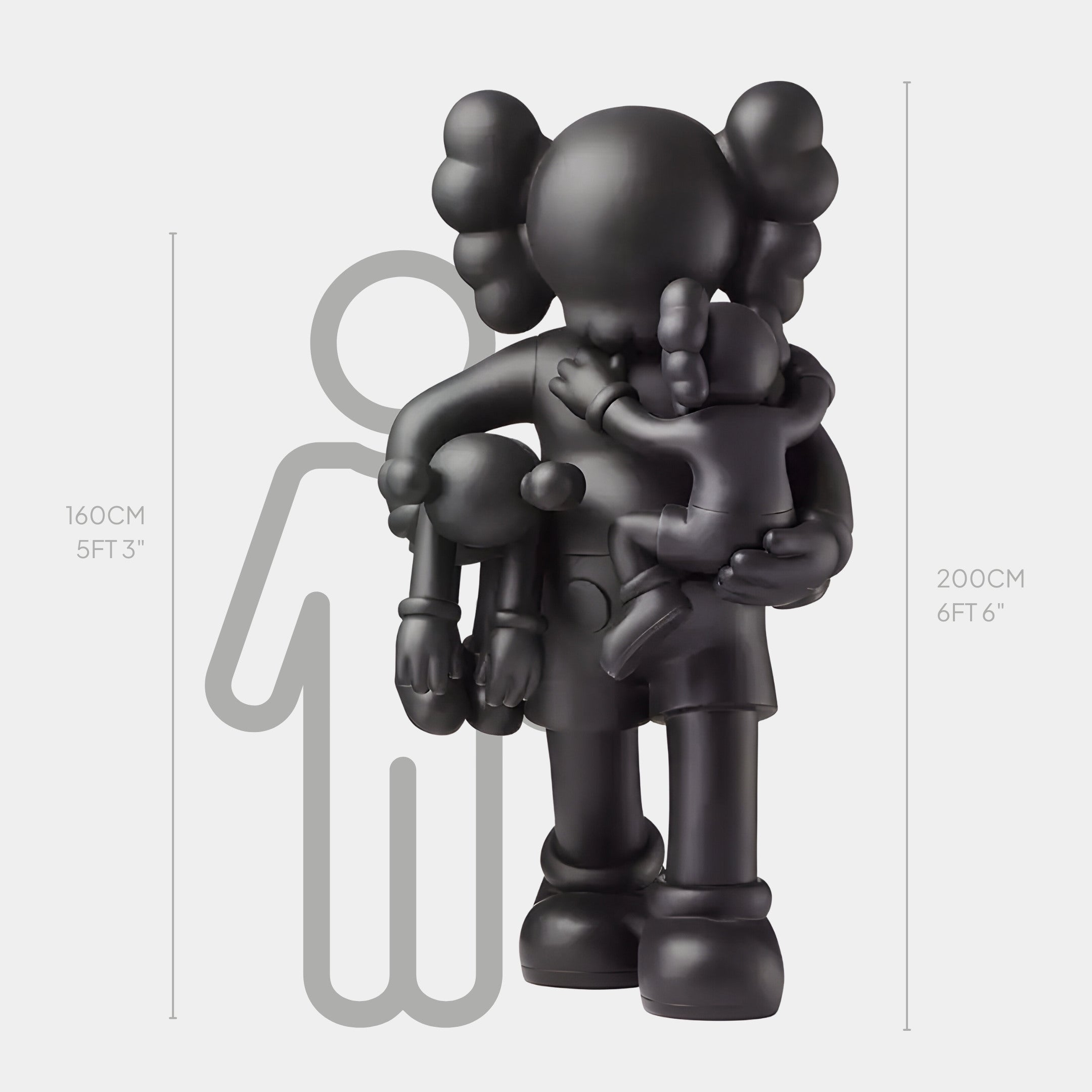 The Midnight Black Iconify Family Sculpture - 200cm by Giant Sculptures is a striking black figurine with two smaller figures against a white backdrop. It towers over a 160 cm (53) grey silhouette of a person, adding artistic flair to minimalist interiors with its modern design.