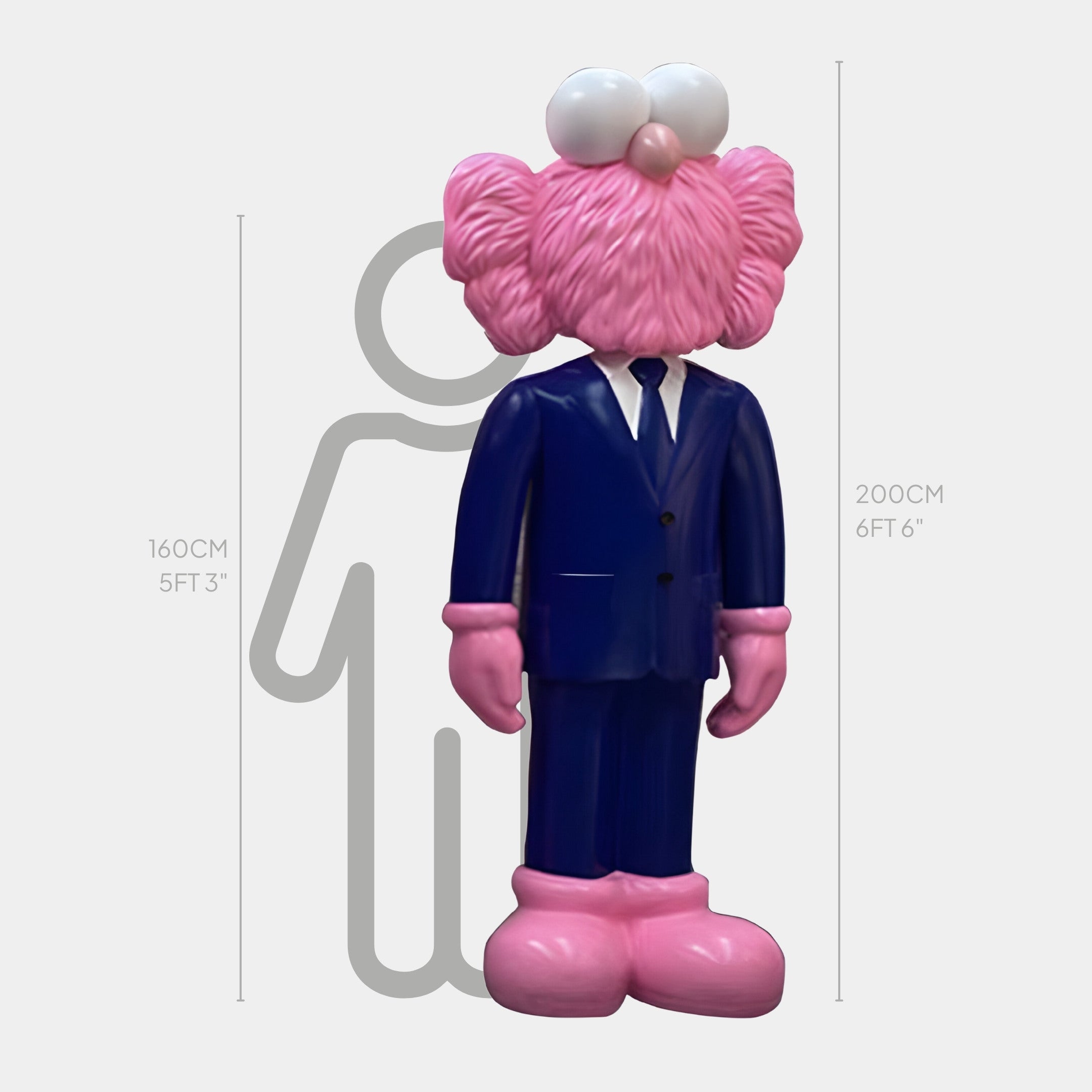 The Iconify CEO Sculpture by Giant Sculptures stands 200 cm tall, featuring a large figure in a navy suit with pink hair, mustache, and shoes. A 160 cm silhouette offers height comparison. This piece adds character to luxury office decor.