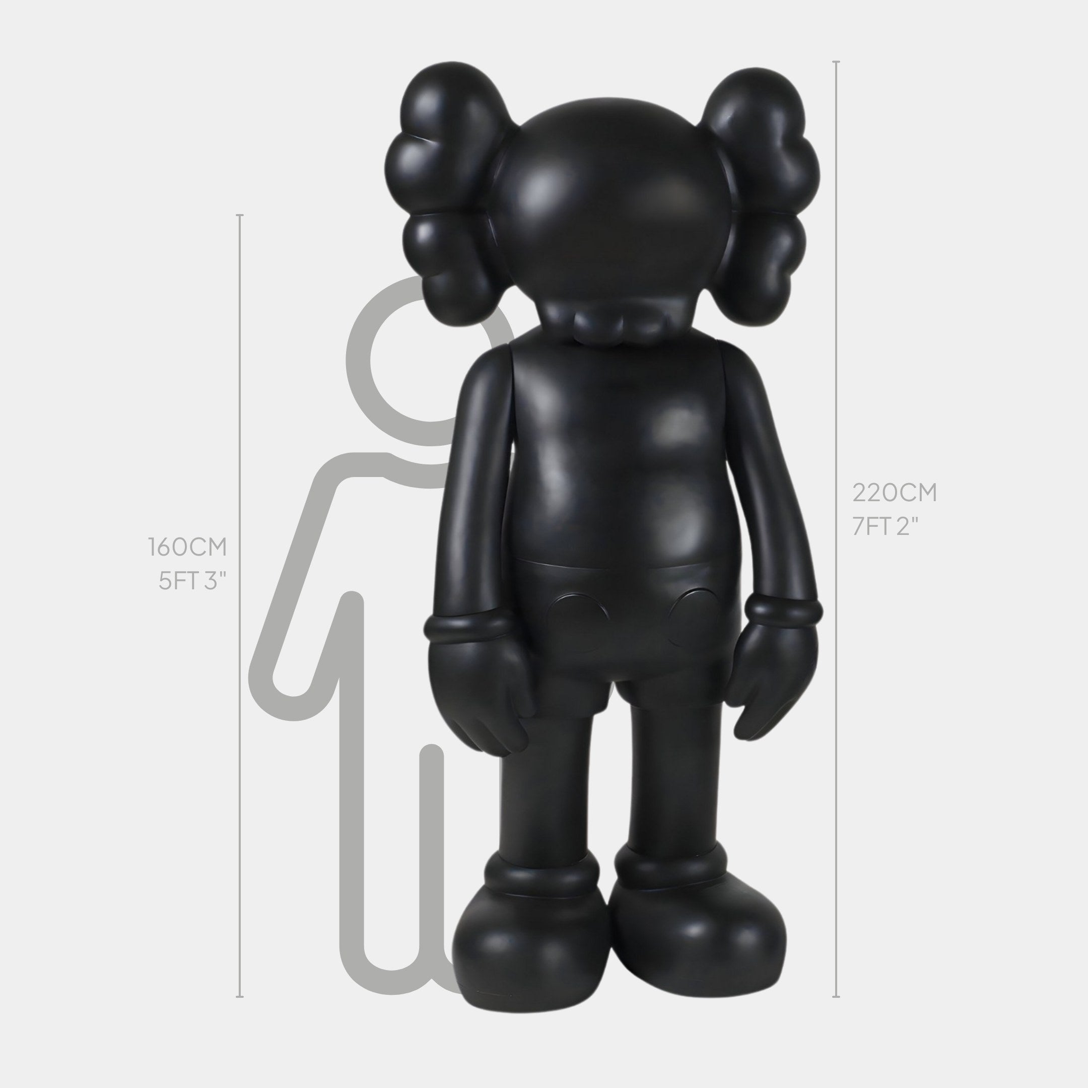 Introducing the Midnight Black Iconify Standing Sculpture by Giant Sculptures: a premium resin figurine, featuring large round ears and crossed eyes, standing at 220 cm (7 ft 2 in) tall. Ideal for contemporary decor, it includes a faint human silhouette of 160 cm (5 ft 3 in) for height comparison.