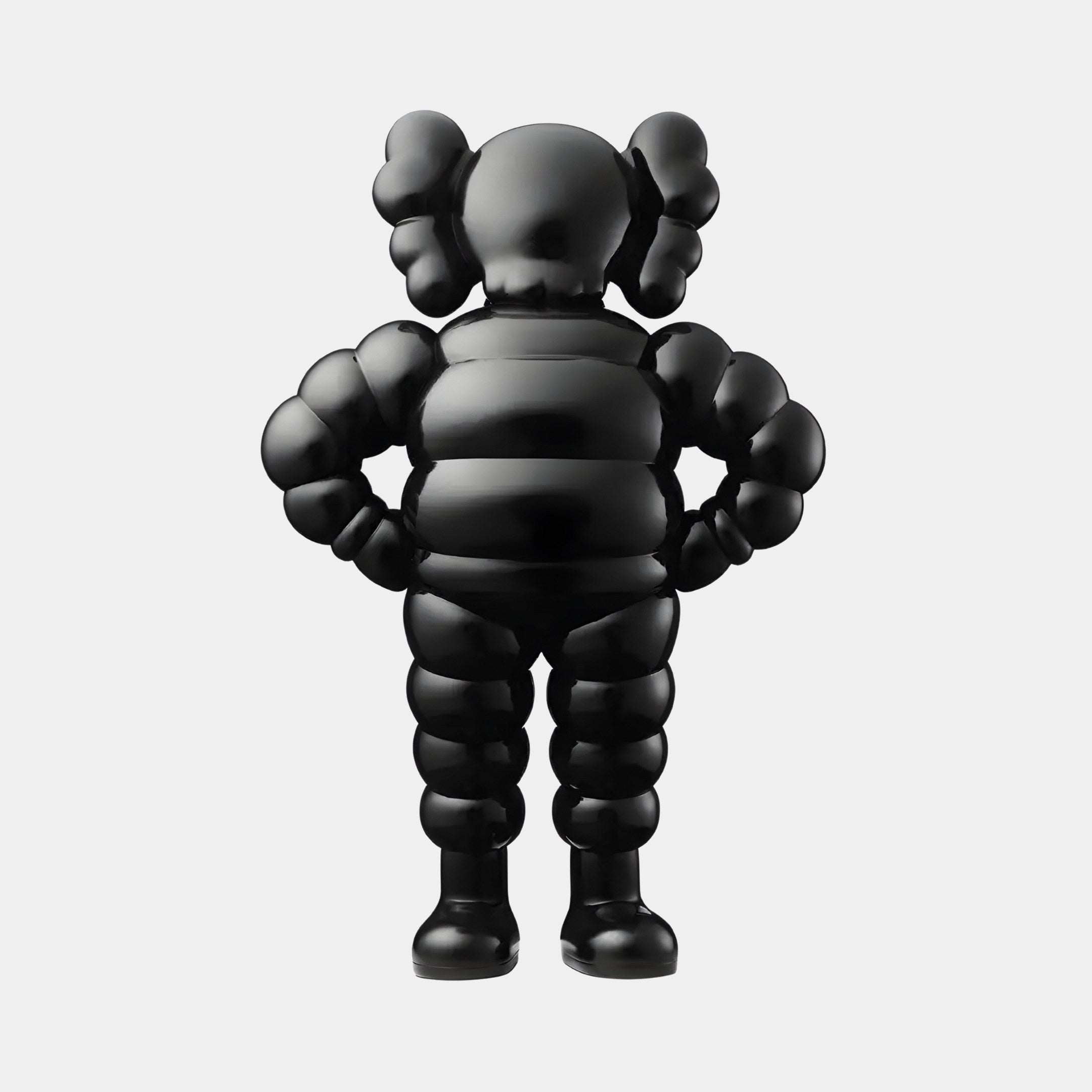 The 80cm Midnight Black Iconify Rollo Warrior Sculpture by Giant Sculptures is an abstract humanoid figure with exaggerated forms, featuring large rounded ears and hands on hips. It stands against a white background, adding charm to contemporary interiors with its balloon-like character poised for action.