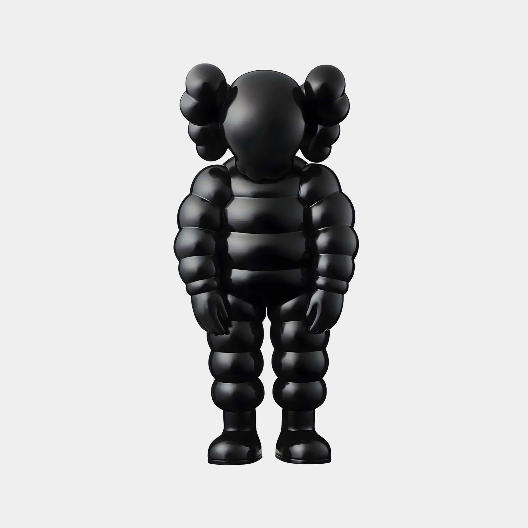 The Charcoal Black Iconify Rollo Sculpture from Giant Sculptures features a shiny black finish, cartoonish details, round segmented limbs, and ear-like protrusions. This minimalist 80cm piece resembles a balloon figure, perfectly embodying modern minimalism for luxury interiors.