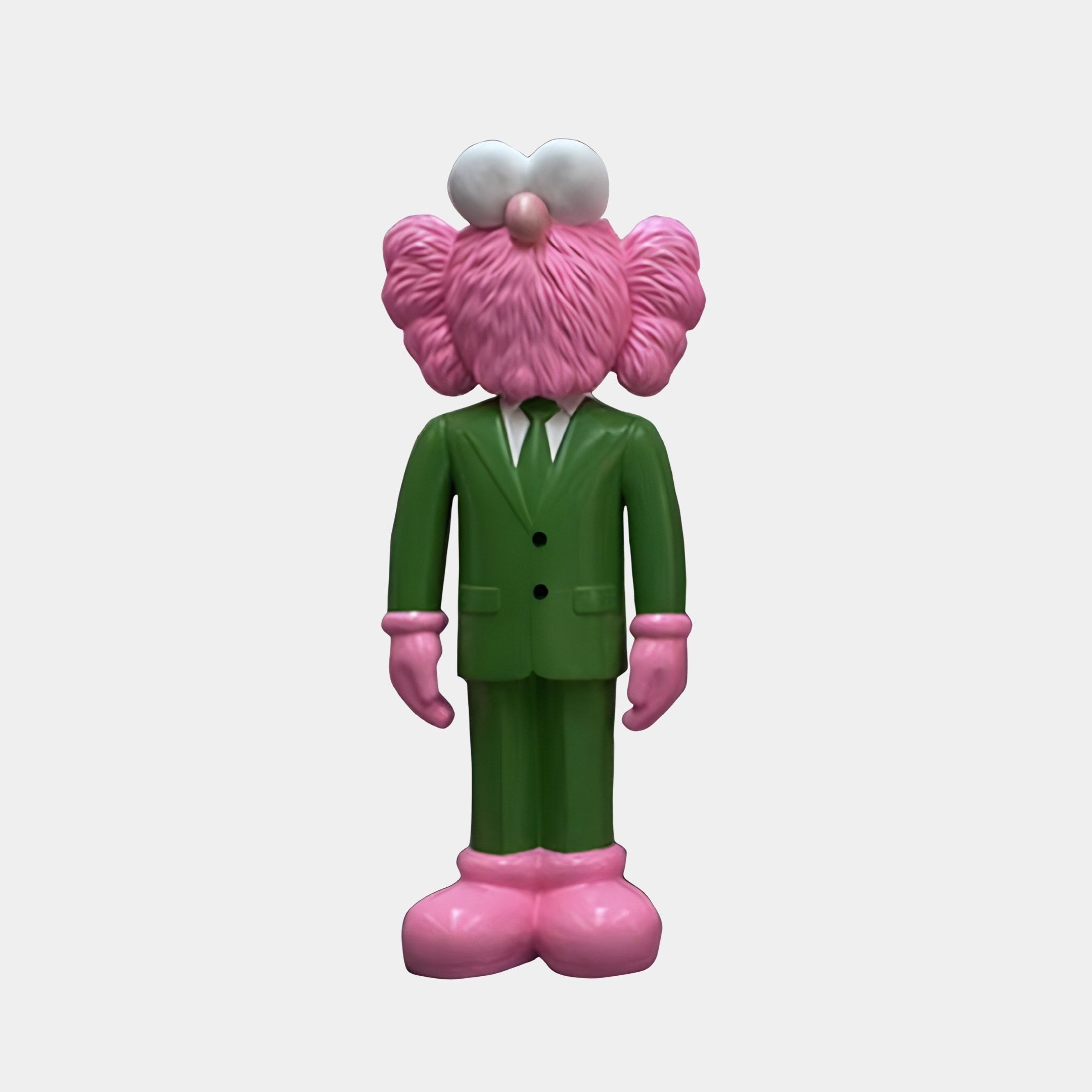 The Forest Green Suit Iconify CEO Sculpture by Giant Sculptures features a whimsical figure in a forest green suit with pink shoes. It has fluffy pink texture on its head and ears, white round eyes, no visible facial features, and is displayed against a plain modern-themed background.