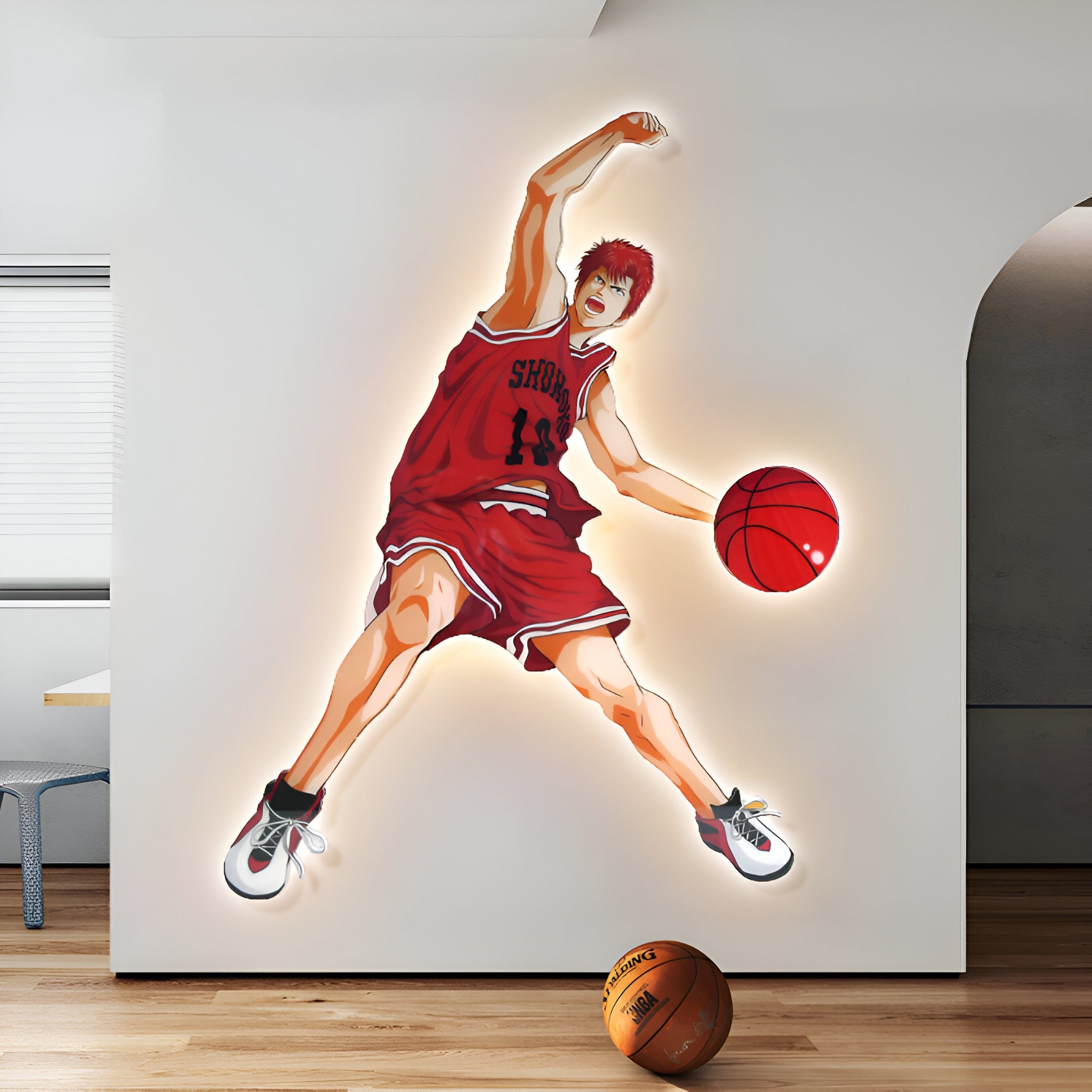 The wall features the Enlustra I Game On UV LED Wall Art by Giant Sculptures, showcasing an animated basketball player in a red jersey (#11) dunking mid-air. A real basketball on the wooden floor complements the vibrant scene enhancing the room’s dynamic flair.