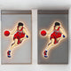 Two adjacent images of a basketball player in a red jersey dribbling are displayed on the wall, capturing dynamic motion with a glowing outline reminiscent of the futuristic energy of the Giant Sculptures Enlustra II Game On UV Wood LED Wall Art.