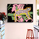 The Juniper II Botanical Escape 3D LED Wall Art by Giant Sculptures showcases a leopard with neon outlines amid pink and green leaves. Below, a red stool complements the countertop adorned with red flowers in a white vase.