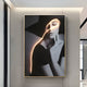 Black and white portrait of a woman in a hat, hand near her face with neon light highlighting her figure. This Giant Sculptures Sylva Noir Muse Canvas LED Wall Art is an exquisite piece perfect for contemporary interiors.