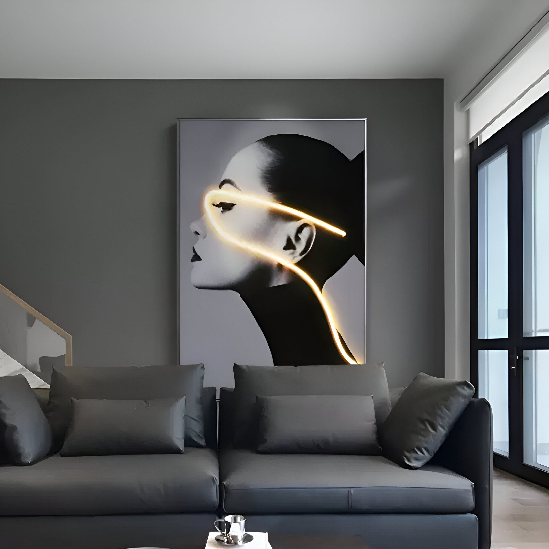 A modern living room exudes elegance with a dark gray sofa and the Sylva Radiant Grace Canvas 3D LED Wall Art by Giant Sculptures. Featuring glowing neon lines, it adds a futuristic effect, while the partially open window blinds flood the space with natural light.