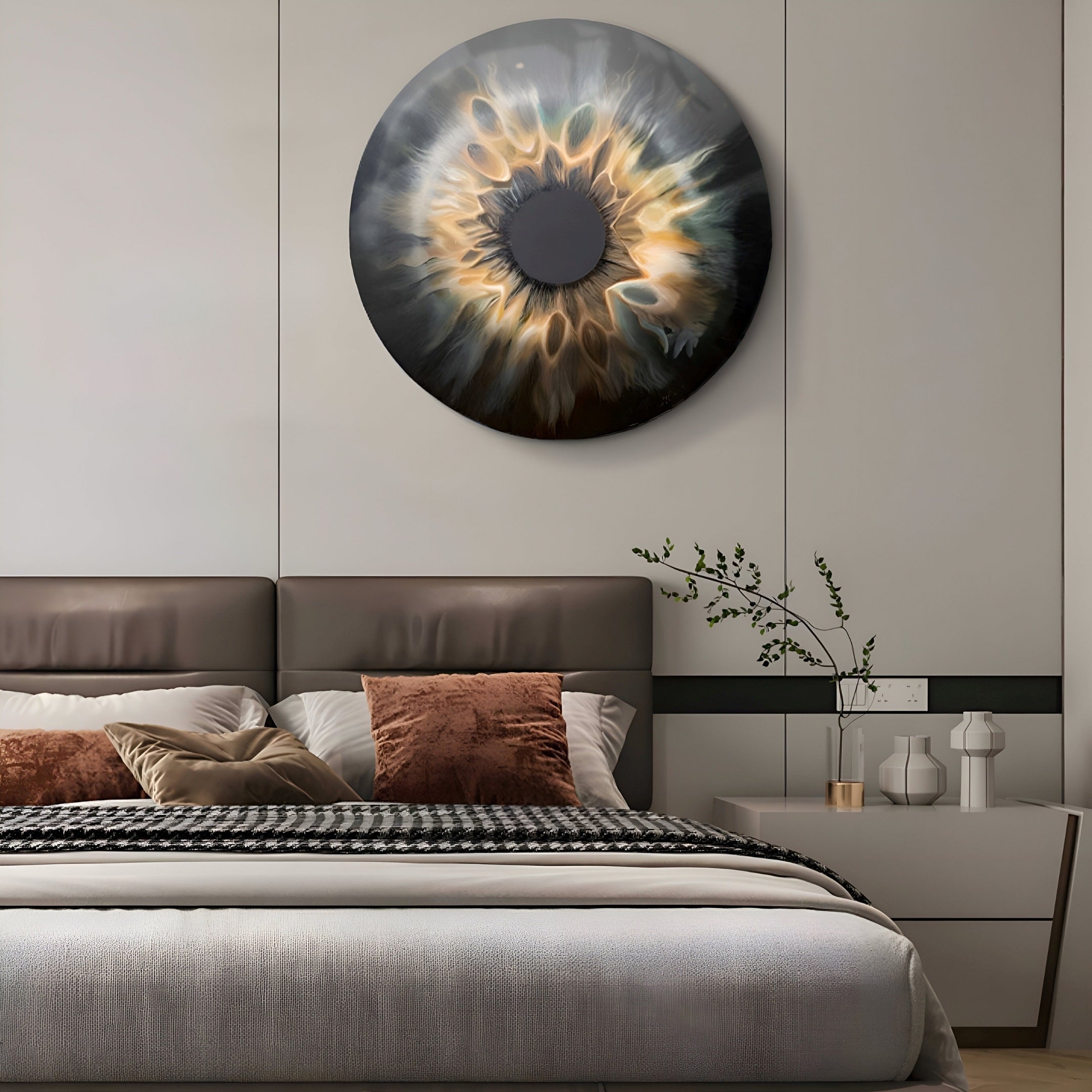 A modern bedroom showcases the Genesis Golden Halo 3D Crystal Resin Porcelain LED Wall Art (H100cm x W100cm) from Giant Sculptures above the bed. The bed features neutral tones with brown and white pillows, while a small plant sits on a nightstand with two white vases near an outlet.