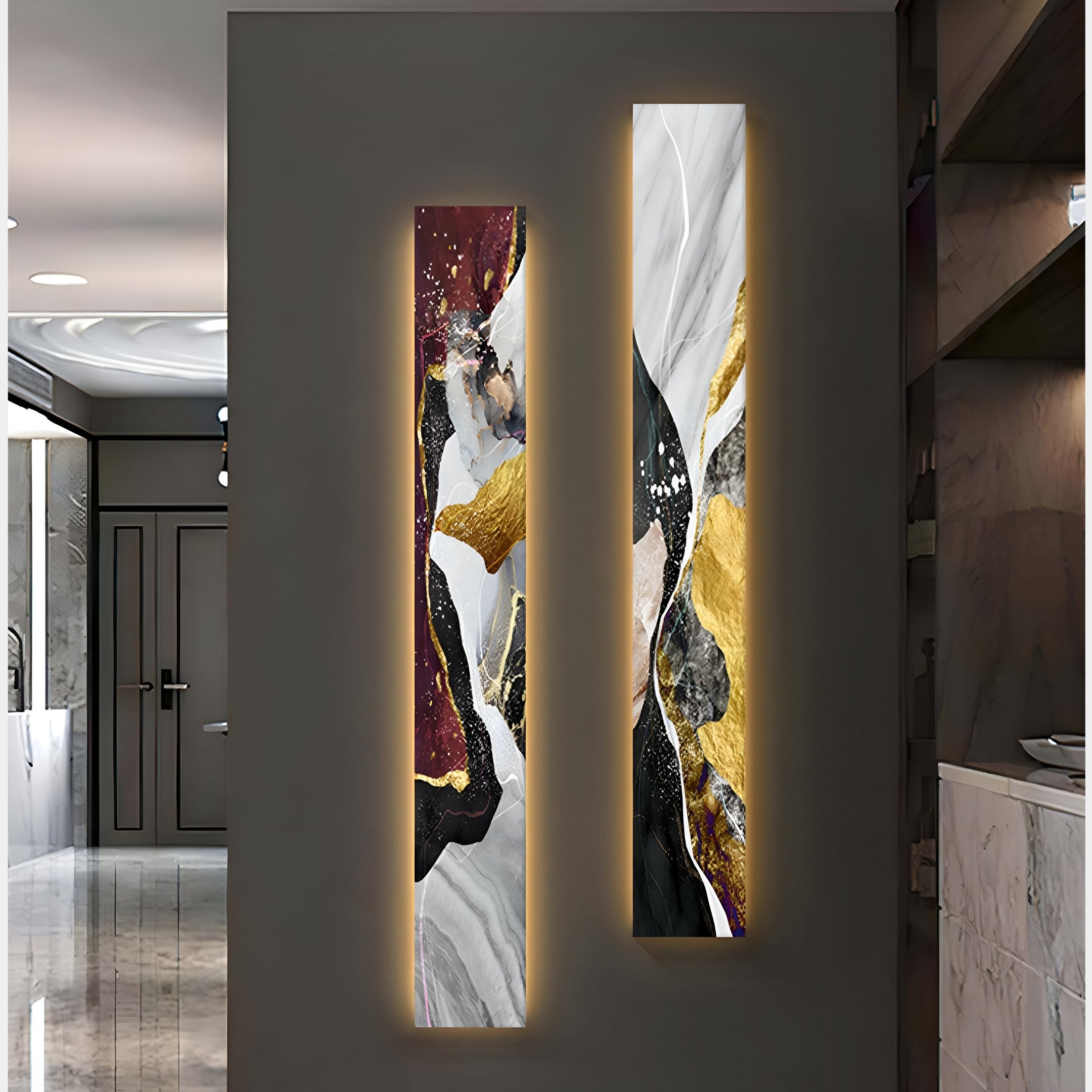 Two vertical Floren Crimson Burst Canvas artworks by Giant Sculptures, in black, gold, maroon, and white hues, are mounted on the wall. Subtle LED lighting casts a warm glow over each piece, complementing the polished modern interior design.