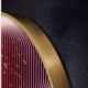 A close-up of the modern art Onyx Flame Glow Acrylic 3D LED Wall Art by Giant Sculptures showcases red and white concentric curves with water droplets. Its framed in a smooth golden border against a textured, dark background.