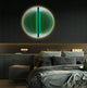 In a sleek, minimalistic bedroom with a dark, textured wall, the Giant Sculptures Onyx Emerald Veil Acrylic 3D LED Wall Art glows in green above a bed with multiple pillows. Nightstands flank the bed, and one holds a small LOVE sign, embodying modern artistry.