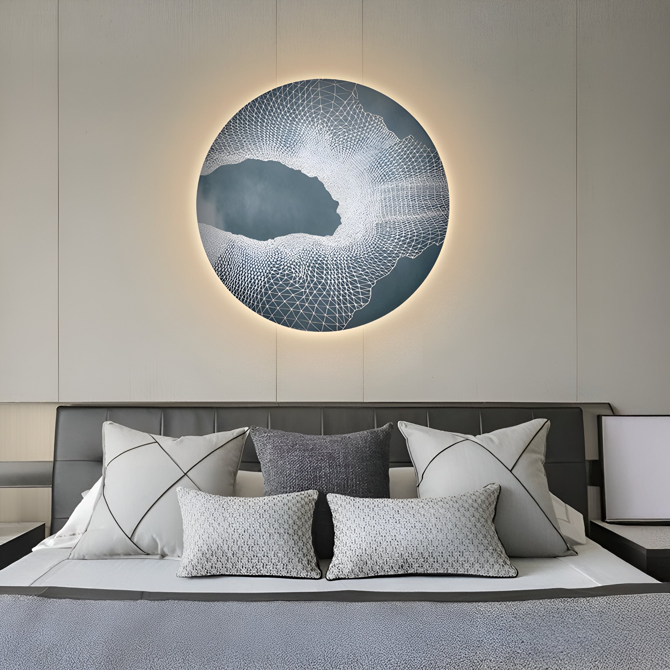 In the modern bedroom, the Earthlight Midnight Mist 3D Textured Oil Painting LED Wall Art by Giant Sculptures graces the wall above a neatly made bed with gray and white pillows and bedding. Soft lighting adds warmth to the neutral-toned room, enhancing its contemporary charm.