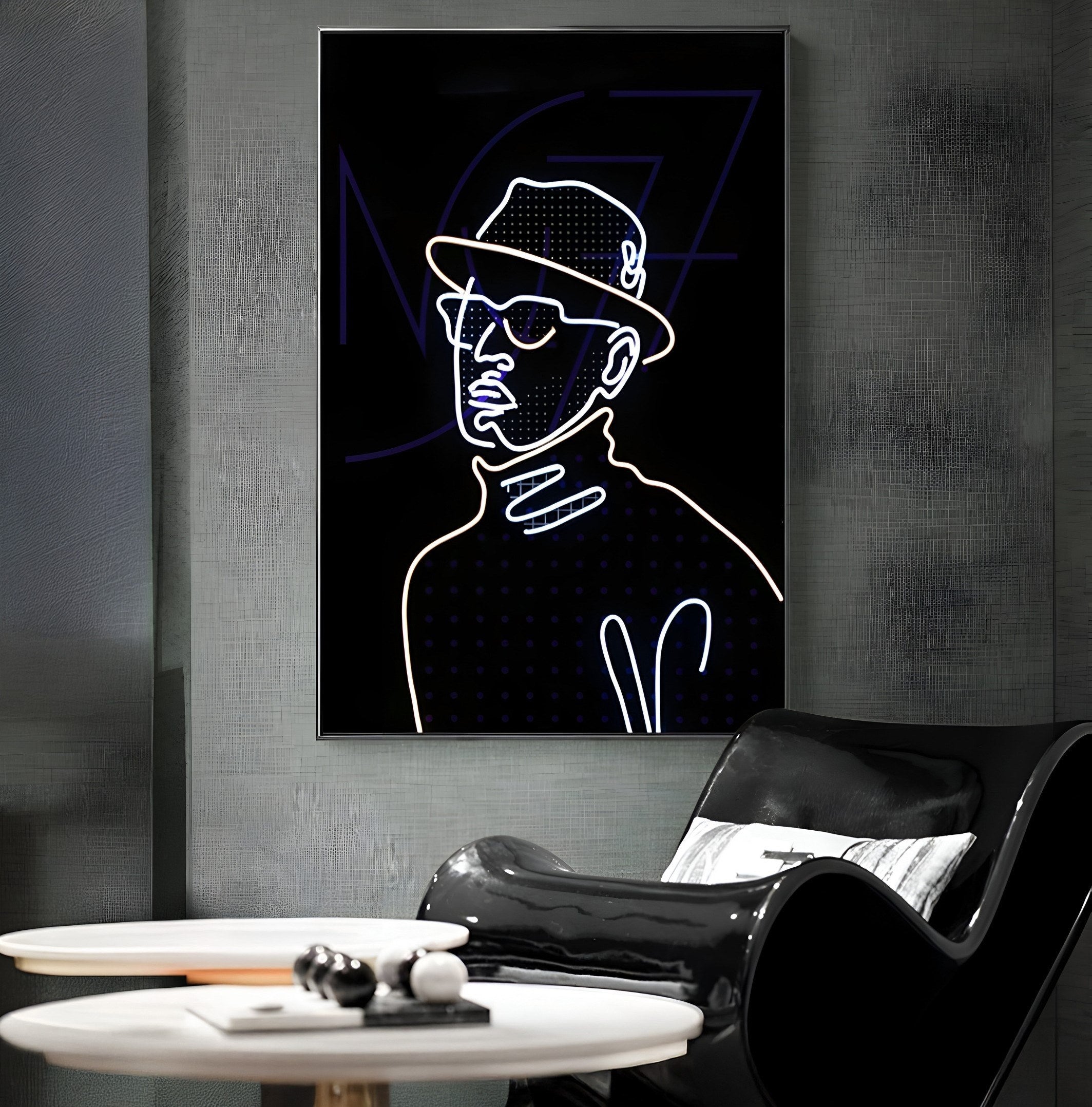 A modern room highlights a Giant Sculptures Polaris Retro Charm Crystal Porcelain 3D LED Wall Art, featuring a minimalist outline of a person in a hat and glasses on a dark background. A sleek black chair and white table with decorative items enhance the stylish setting.