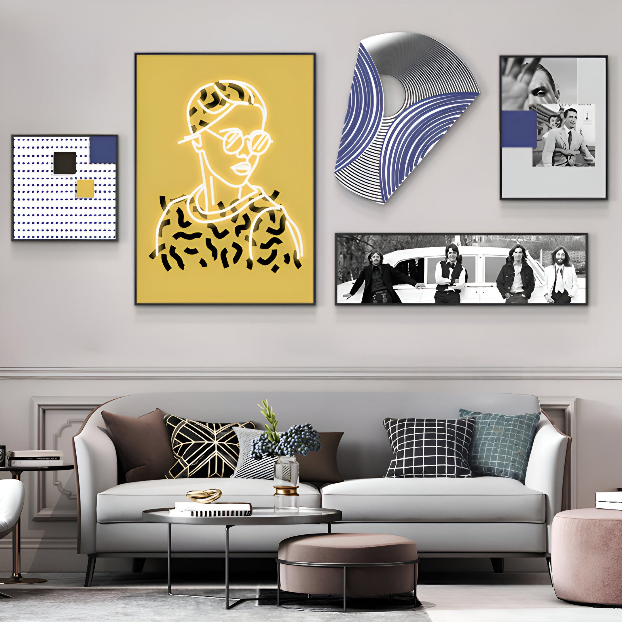 A modern living room with a light gray sofa and patterned cushions exudes a chic aesthetic. It features the Orison Urban Essence Crystal Porcelain LED Wall Art by Giant Sculptures, with abstract portraits and black-and-white photos above the sofa. A small round coffee table sits in front.