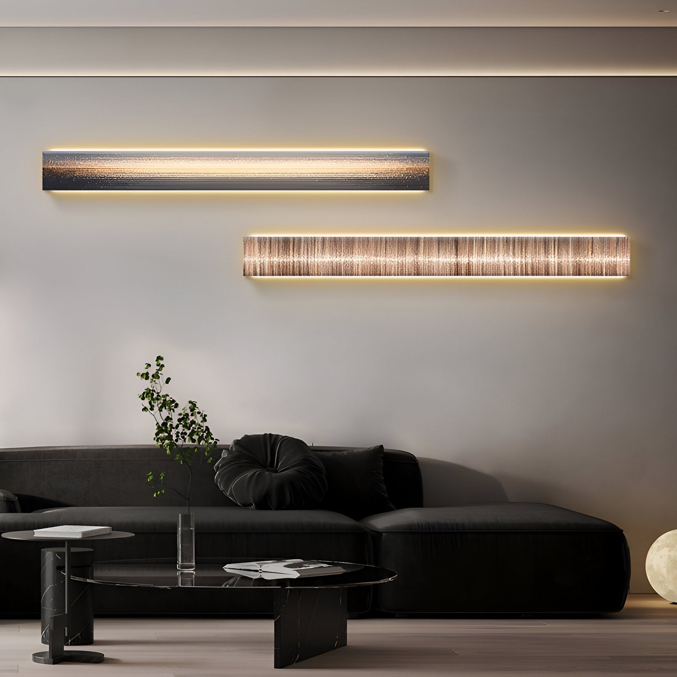 In a modern living room, a sleek black sofa and round cushion are accentuated by wall-mounted linear lights. The Radiance Amber Dusk Canvas LED Wall Art by Giant Sculptures illuminates the scene, while a small round table and plant enhance the decor. A soft globe light rests on the floor.