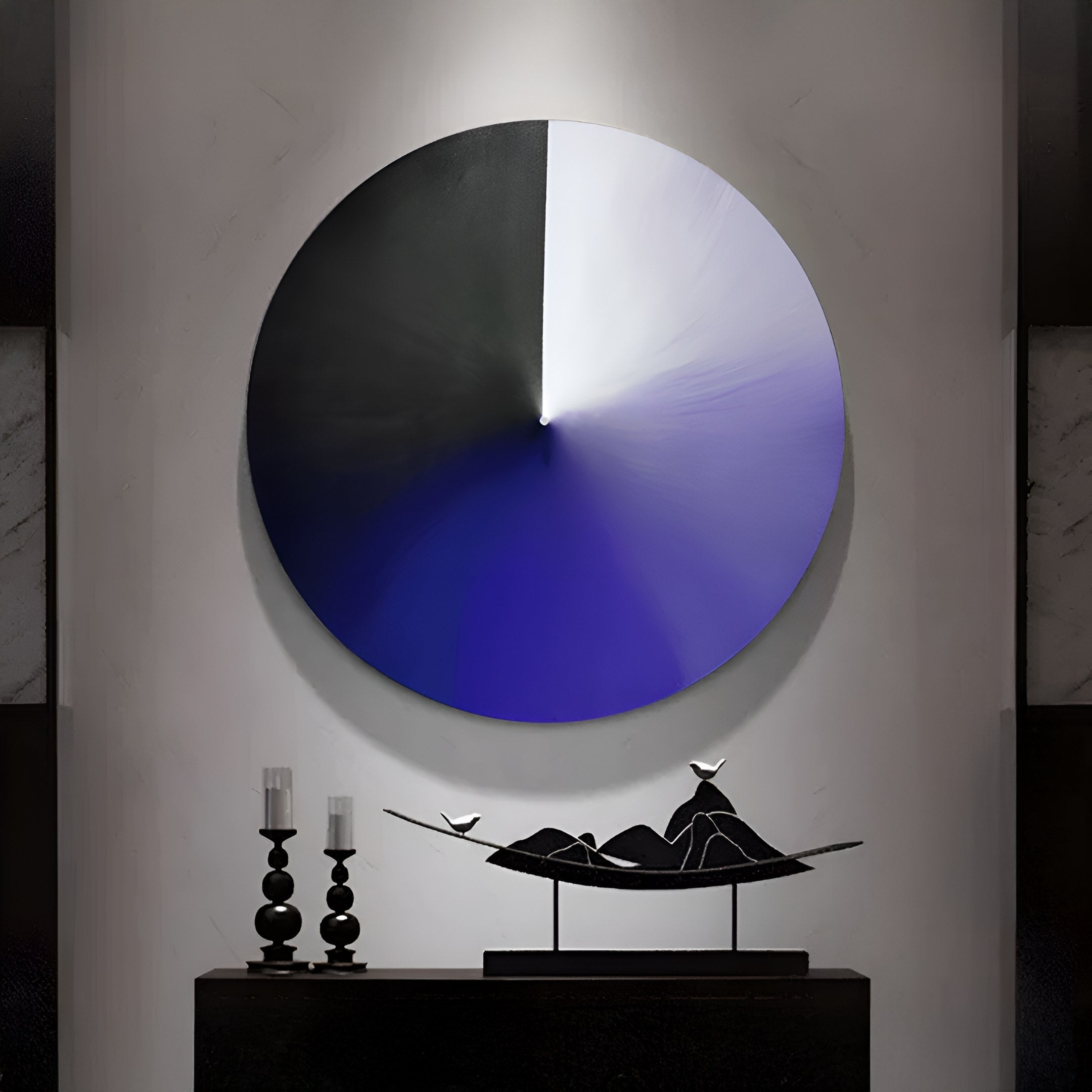 A Giant Sculptures Orbit Violet Hand-Painted Canvas 3D LED Wall Art, featuring a serene circular gradient of black, white, and blue, adorns the wall. Below lies a minimalist black sculpture of a figure on a boat with a bird beside it, flanked by two candlesticks—a tranquil yet thought-provoking tableau.