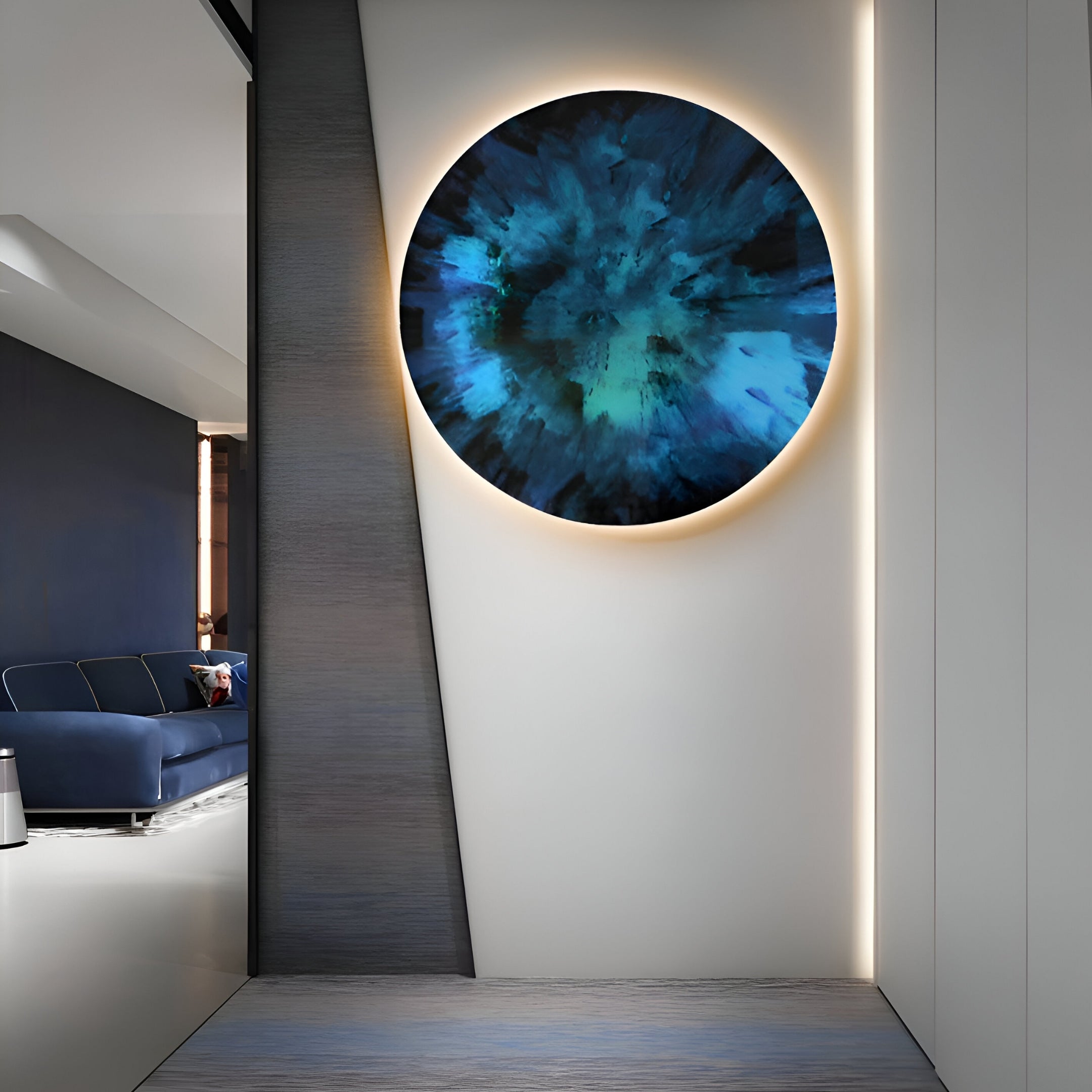 A modern interior features the Lumea Textured Deep Blue 3D LED Crystal Porcelain Wall Art by Giant Sculptures, mounted on a white wall and softly backlit with warm light. The minimalist decor hints at a blue couch on the left, with sleek polished floors and walls enhancing the sophisticated look.