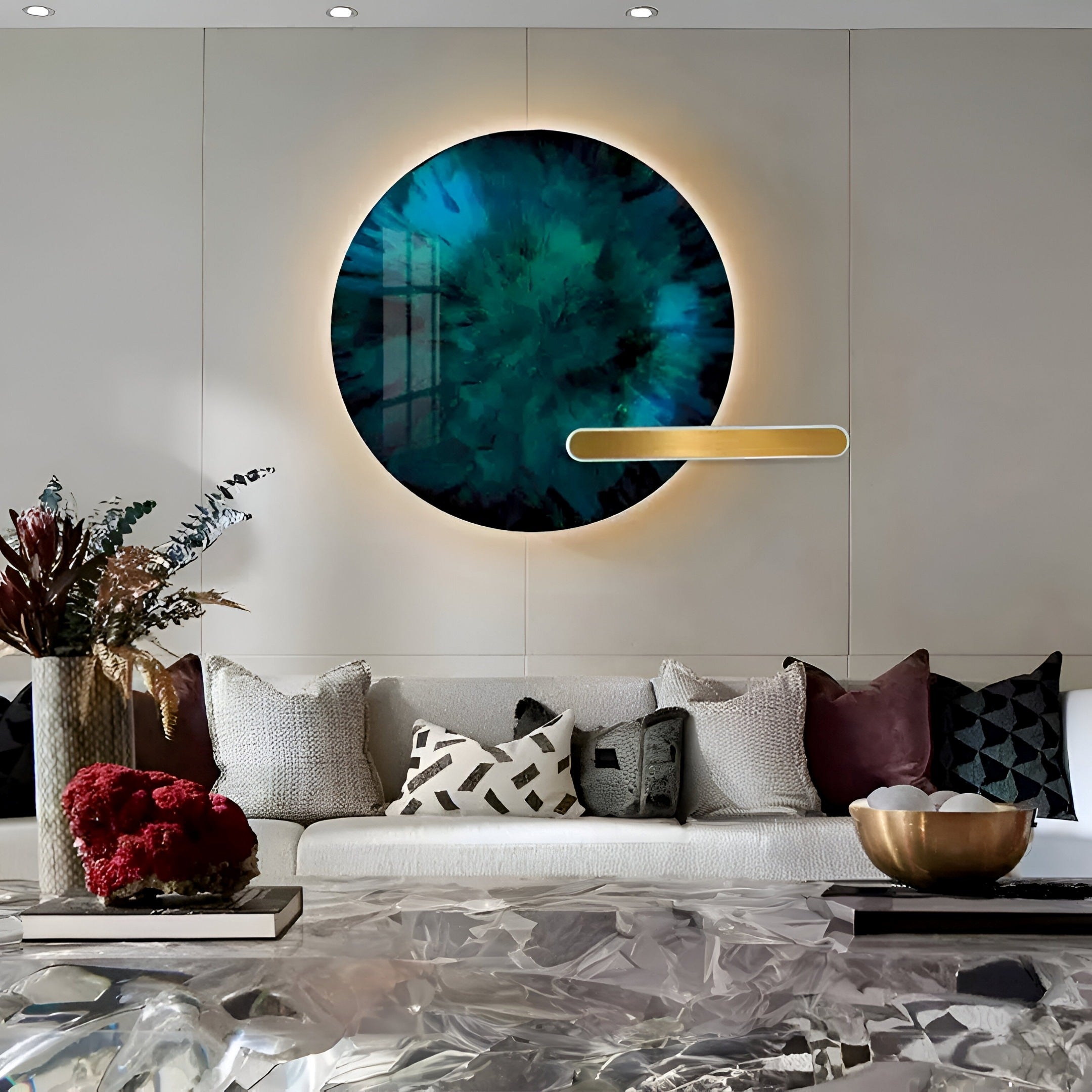 A chic modern living room showcases the Lumea Abstract Turquoise 3D LED Crystal Porcelain Wall Art by Giant Sculptures on a white wall. Below, a couch with patterned cushions pairs with a glass coffee table adorned with decorative items and flanked by potted plants.