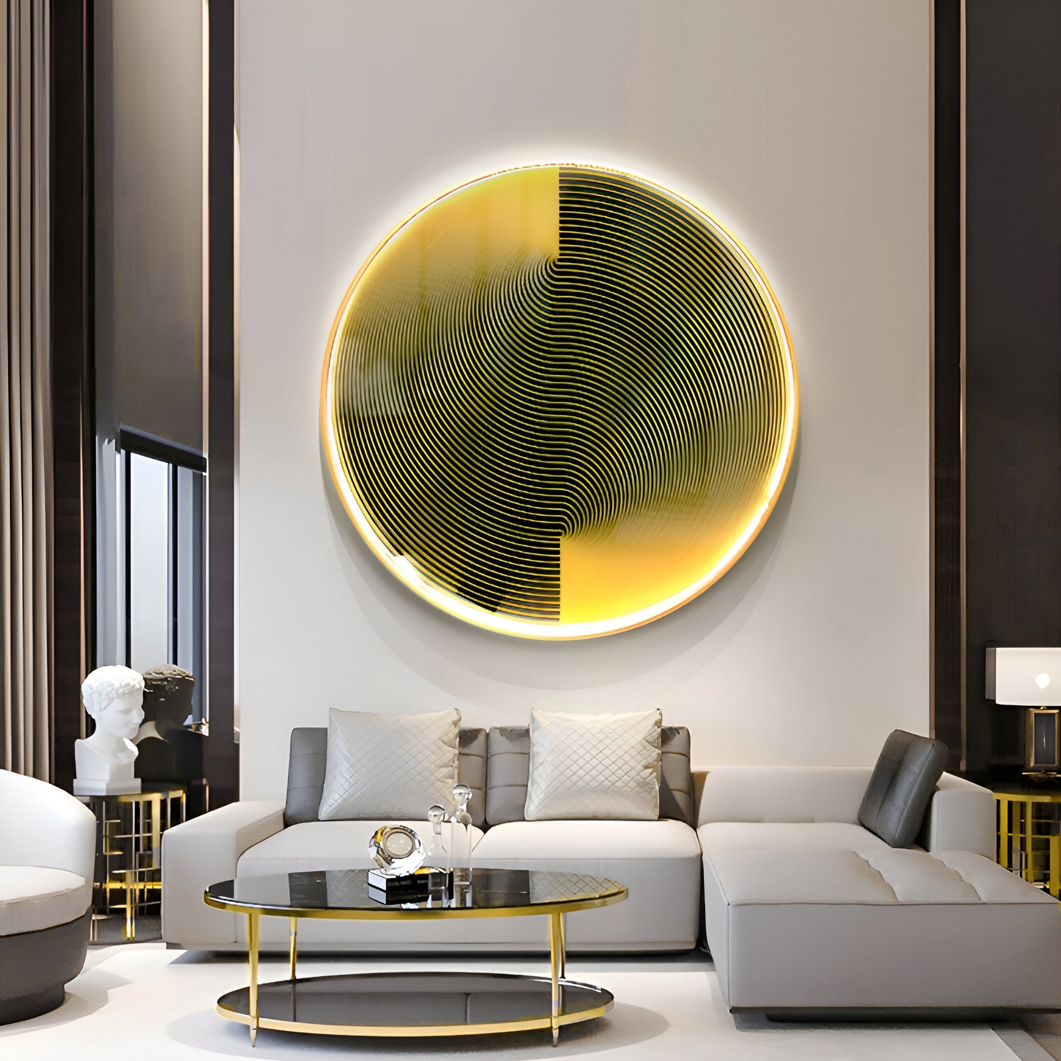 In a modern living room, the Astral Gold Crystal Porcelain LED Wall Art from Giant Sculptures showcases a large circular abstract piece. A gray sectional sofa complements a black glass coffee table with an aluminum frame, creating neutral decor and warm ambiance.