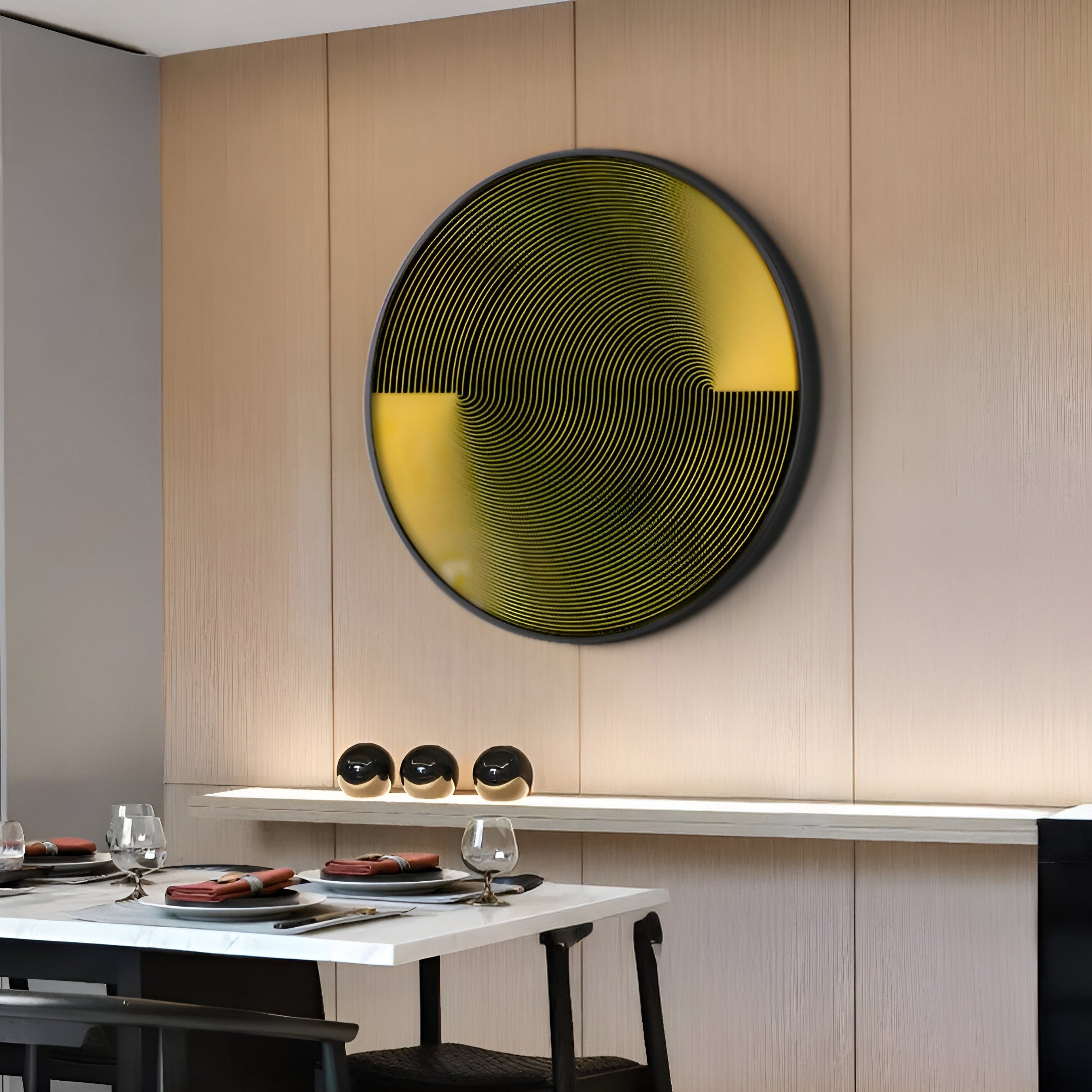 A modern dining room with a wooden wall showcases the Astral Gold Crystal Porcelain LED Wall Art by Giant Sculptures in yellow and black. Below, a table is set with glassware and red napkins. An aluminum frame holds three small black-and-white decorative spheres on a shelf above the table.