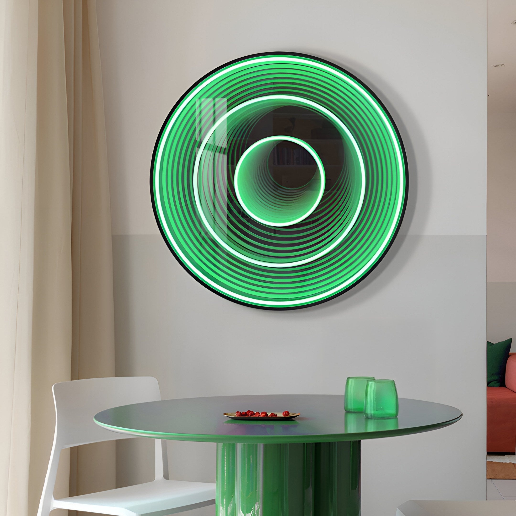 The Reflex Emerald Mirror 3D LED Wall Art by Giant Sculptures is mounted above a round table holding a green rectangular object and a small plate with red items. Nearby, theres a white chair, and a beige curtain is partially visible.