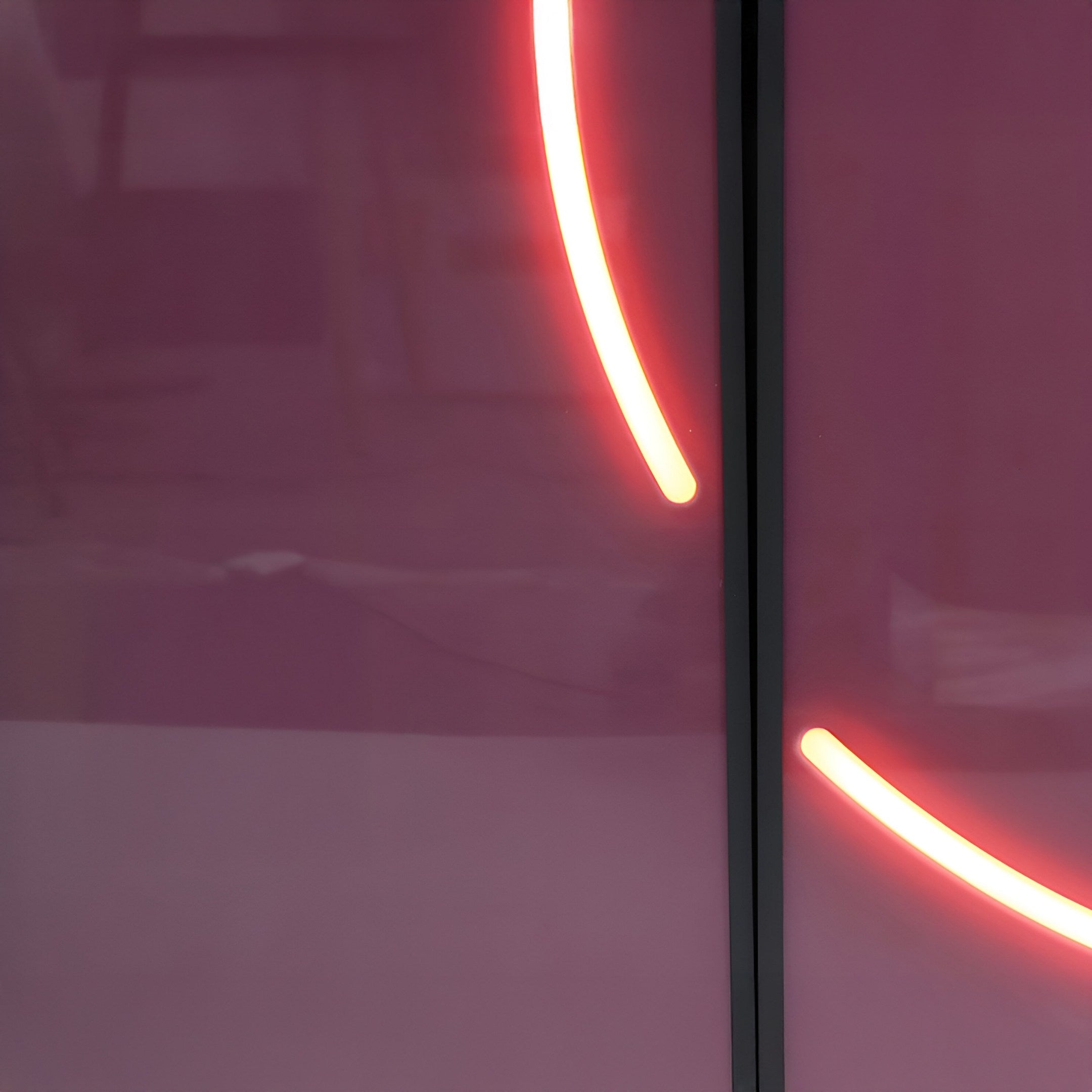 The Enigma Rosewood Glow LED Wall Art by Giant Sculptures features a partial neon arc against a reflective pink and dark surface with a crystal porcelain effect, creating minimalist and abstract beauty.