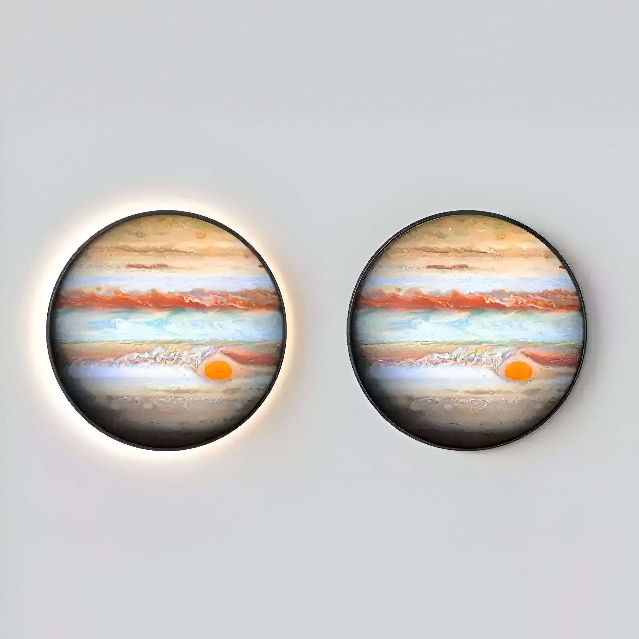 The Galaxia Jupiter Crystal Porcelain LED Wall Art by Giant Sculptures features two round lights depicting Jupiters colorful bands and Great Red Spot, enhanced by an even-glowing LED system that highlights the realistic planetary design against a light gray background.