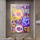 The Giant Sculptures Elysian Chromatic Vortex Oil Painting features a vibrant abstract design with neon orange, yellow, blue, and purple swirls. As 3D LED wall art on a neutral-toned background, it pairs beautifully with small decorative plants beneath.