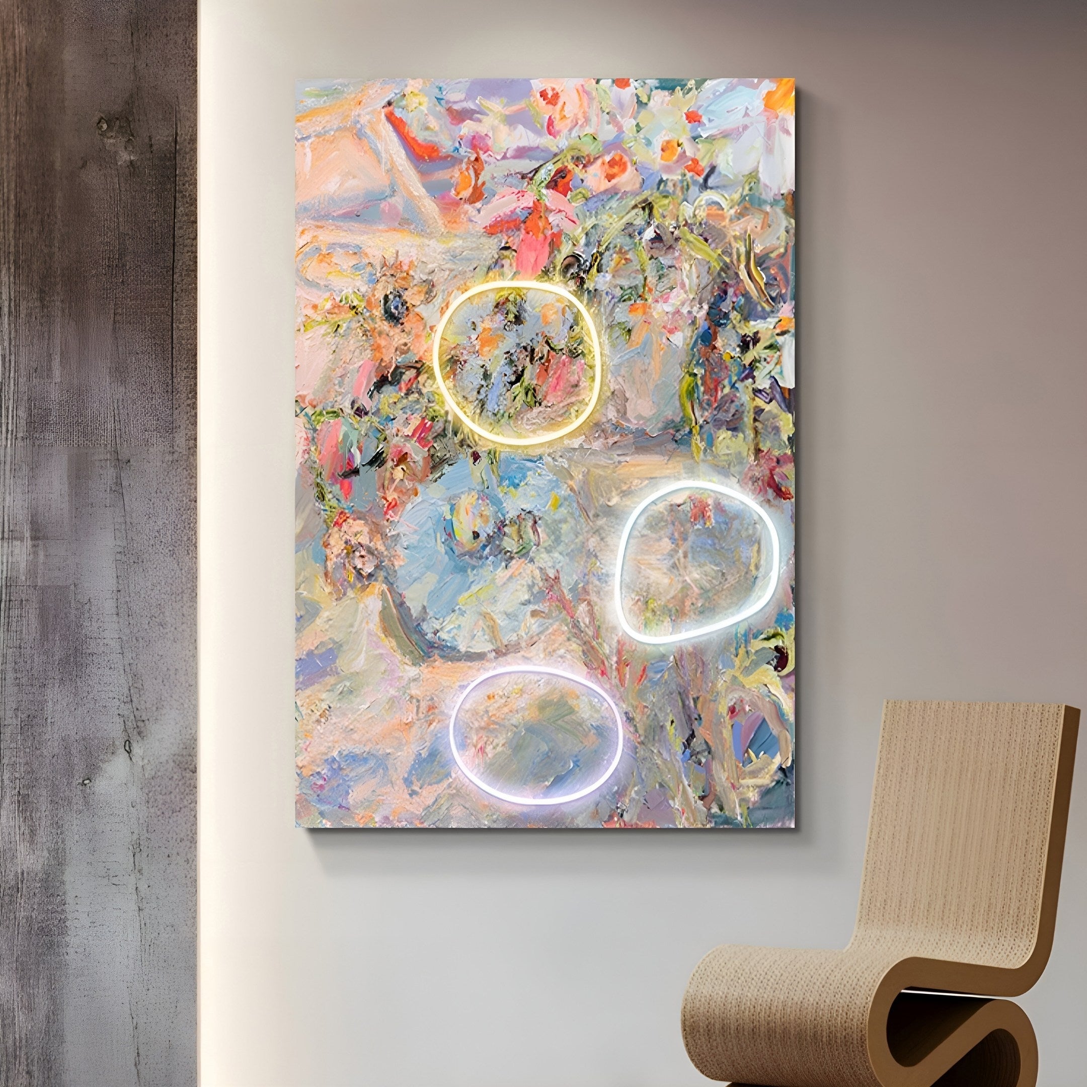 The Elysian Pastel Bloom Oil Painting by Giant Sculptures features pastel colors, dynamic brush strokes, and three neon light circles in various shades. This 3D LED wall art is displayed on a textured wall next to a modern curved wooden chair.