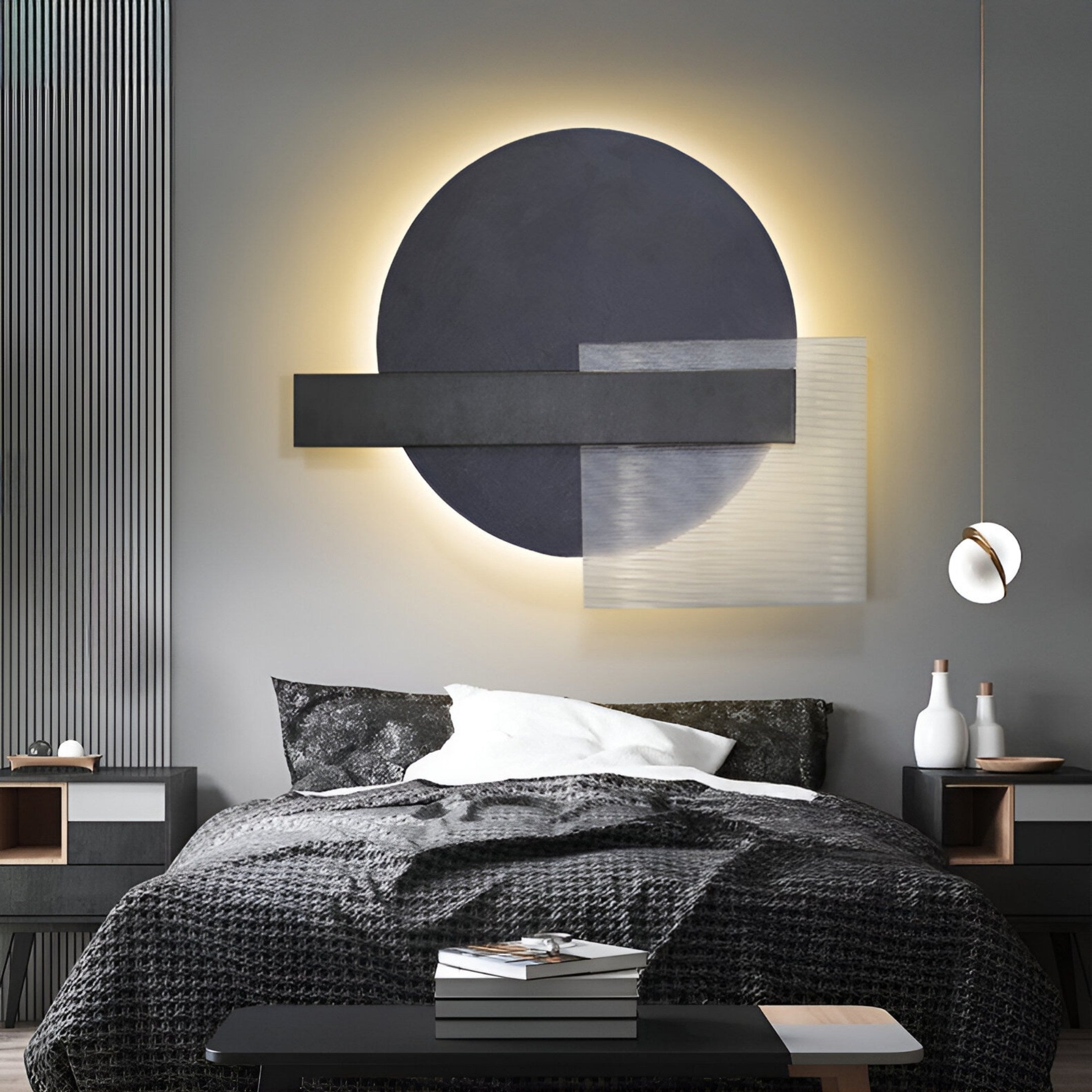 A modern bedroom features an Aeon Onyx Graphite Leather 3D LED Wall Art by Giant Sculptures, with geometric shapes and subtle backlighting. The bed includes a textured gray blanket and crisp white pillows, while minimalist side tables display chic decor against soothing neutral walls and furnishings.