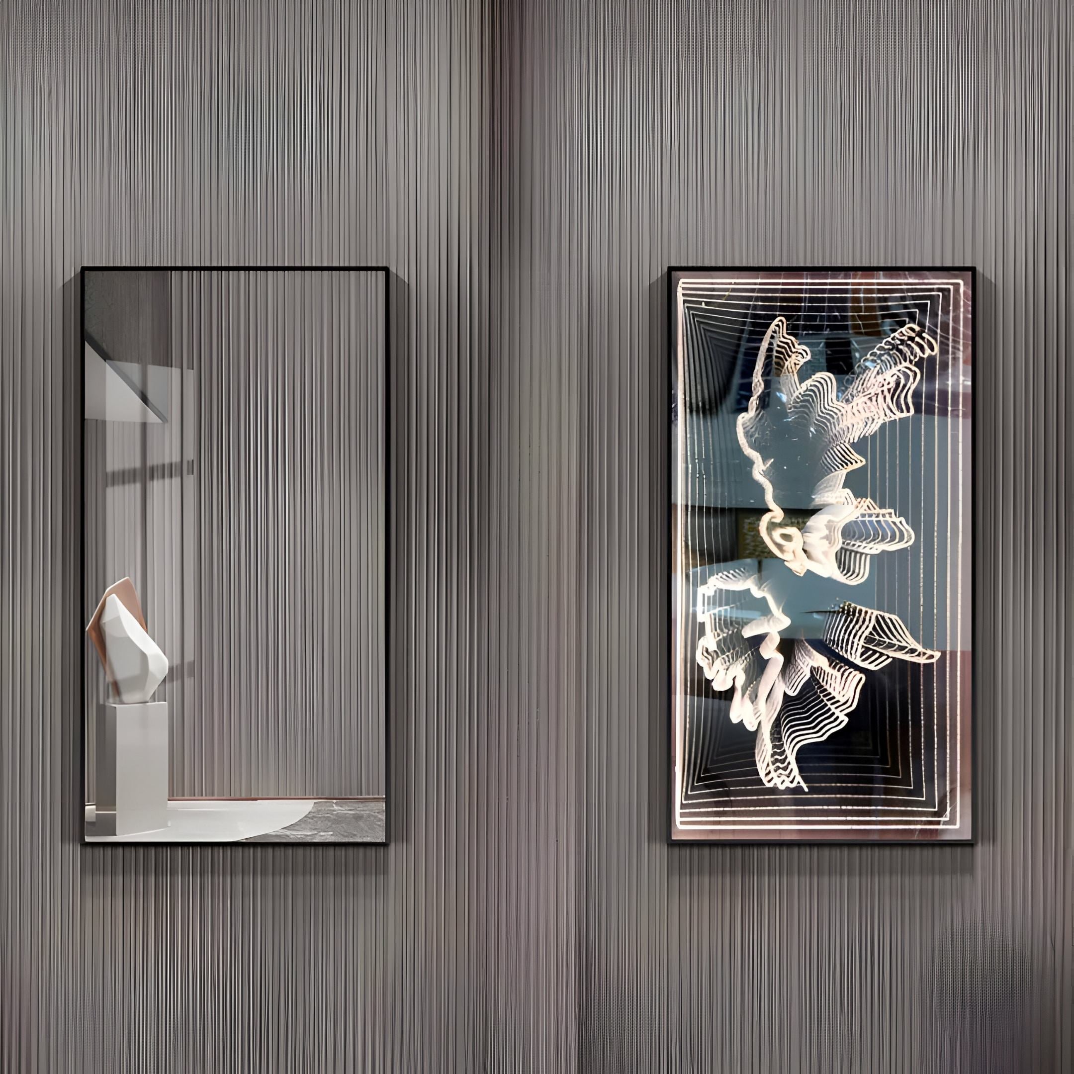 Two rectangular frames adorn a textured gray wall. The left displays the Horizon Butterfly Harmony 3D LED Mirror by Giant Sculptures, casting light on a white sculpture. The right features an abstract 3D art piece with swirling patterns and black accents, epitomizing modern decor.