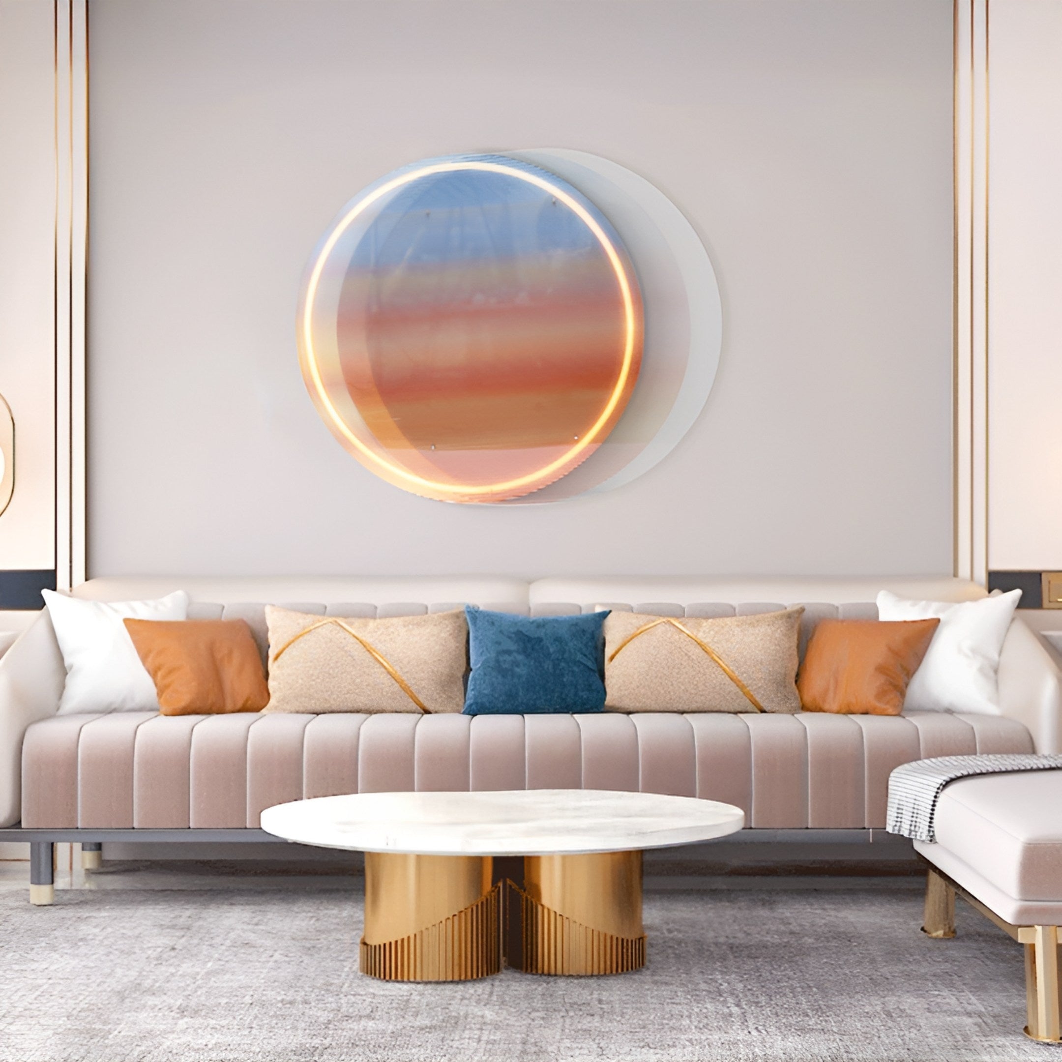 A modern living room showcases a beige sofa with orange, beige, and blue cushions. Above it hangs the captivating Chromia Sunrise Glow Acrylic LED Wall Art by Giant Sculptures. Below is a round coffee table with a white top and gold base.