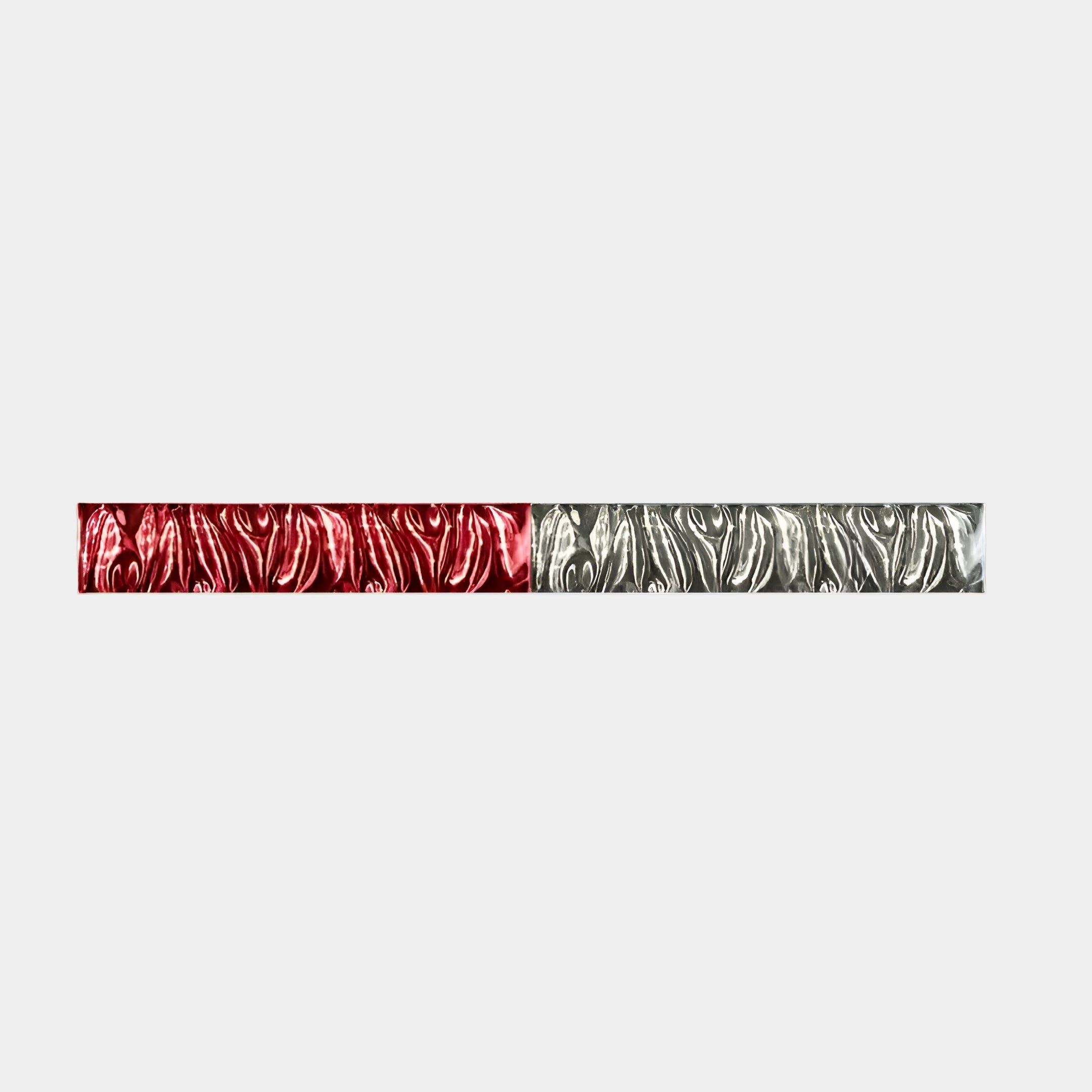 The Textura 3D Red and Silver Leather Design Wall Art by Giant Sculptures is a modern masterpiece. It features a long strip split into two: the left in red with swirling texture, the right in silver, set against a light gray background that highlights the striking colors.