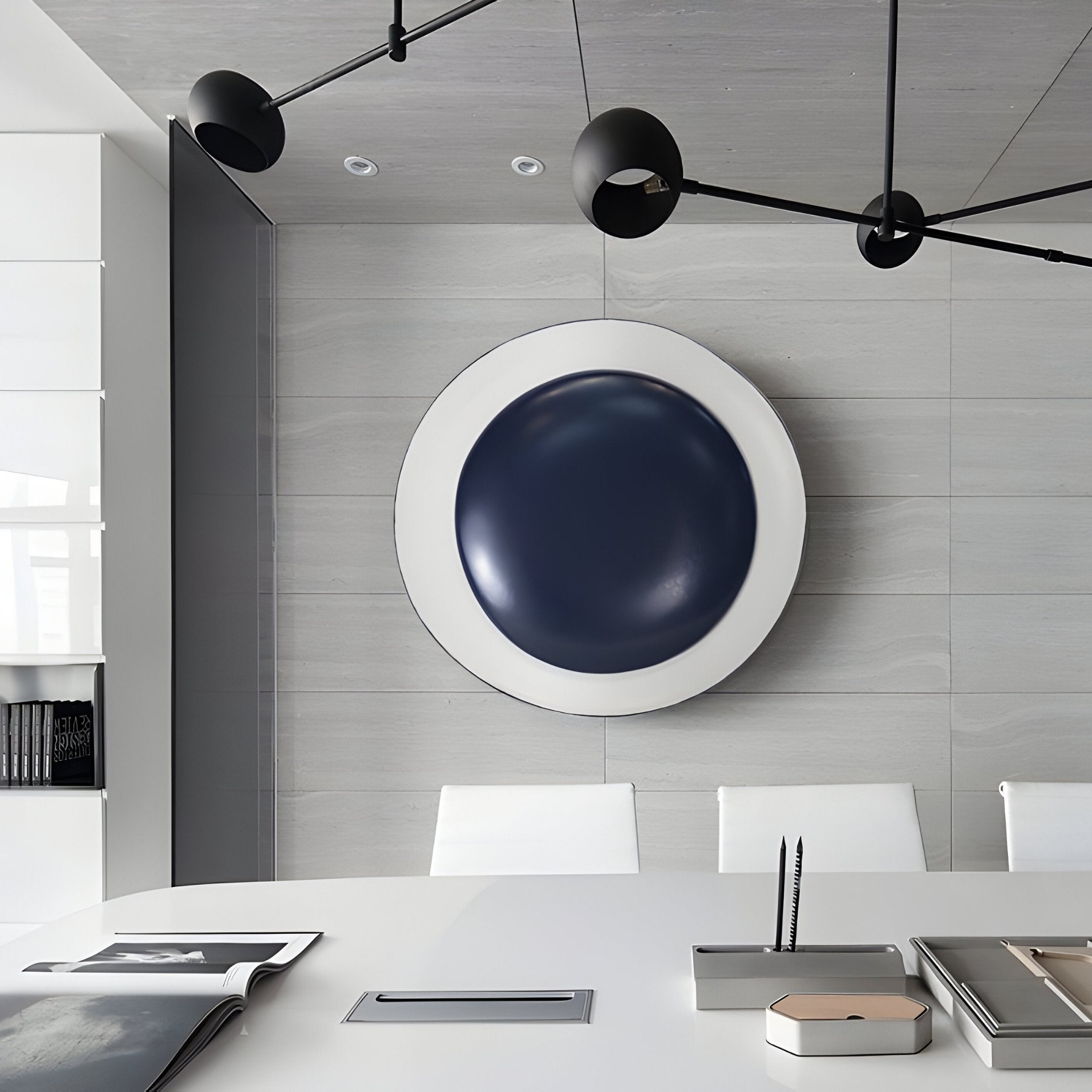 A modern office interior features the Aetherial Midnight Blue Glossy Circular Symmetry 3D Wall Art by Giant Sculptures. Complemented by a white conference table, minimalistic decor, black ceiling lights, and white chairs, it creates a sleek and professional atmosphere.