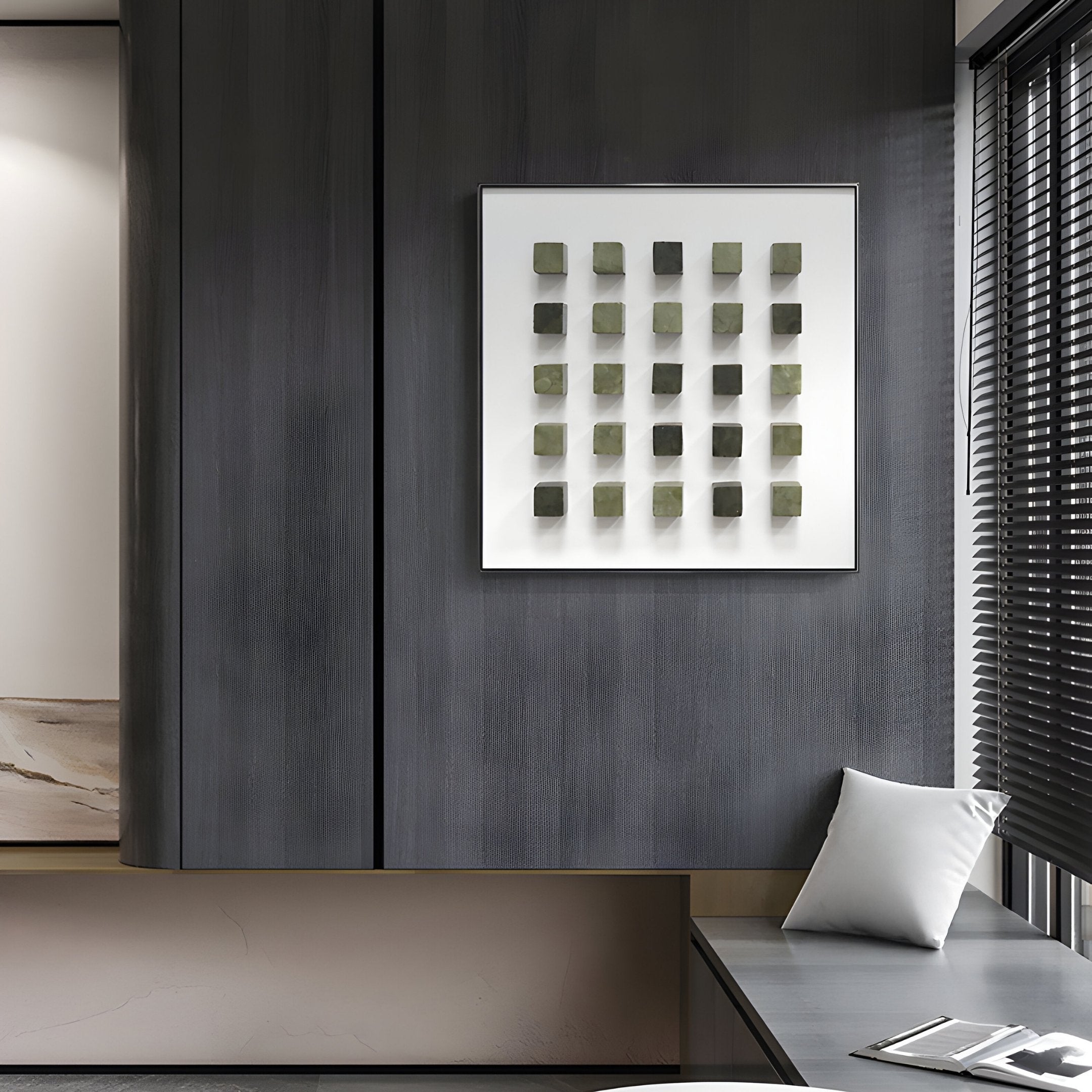 A minimalist interior features dark wood paneling, the Cubitara Green Gradient Wood Block 3D Wall Art by Giant Sculptures, a soft cushion on a built-in bench, and natural light streaming through partially open blinds.