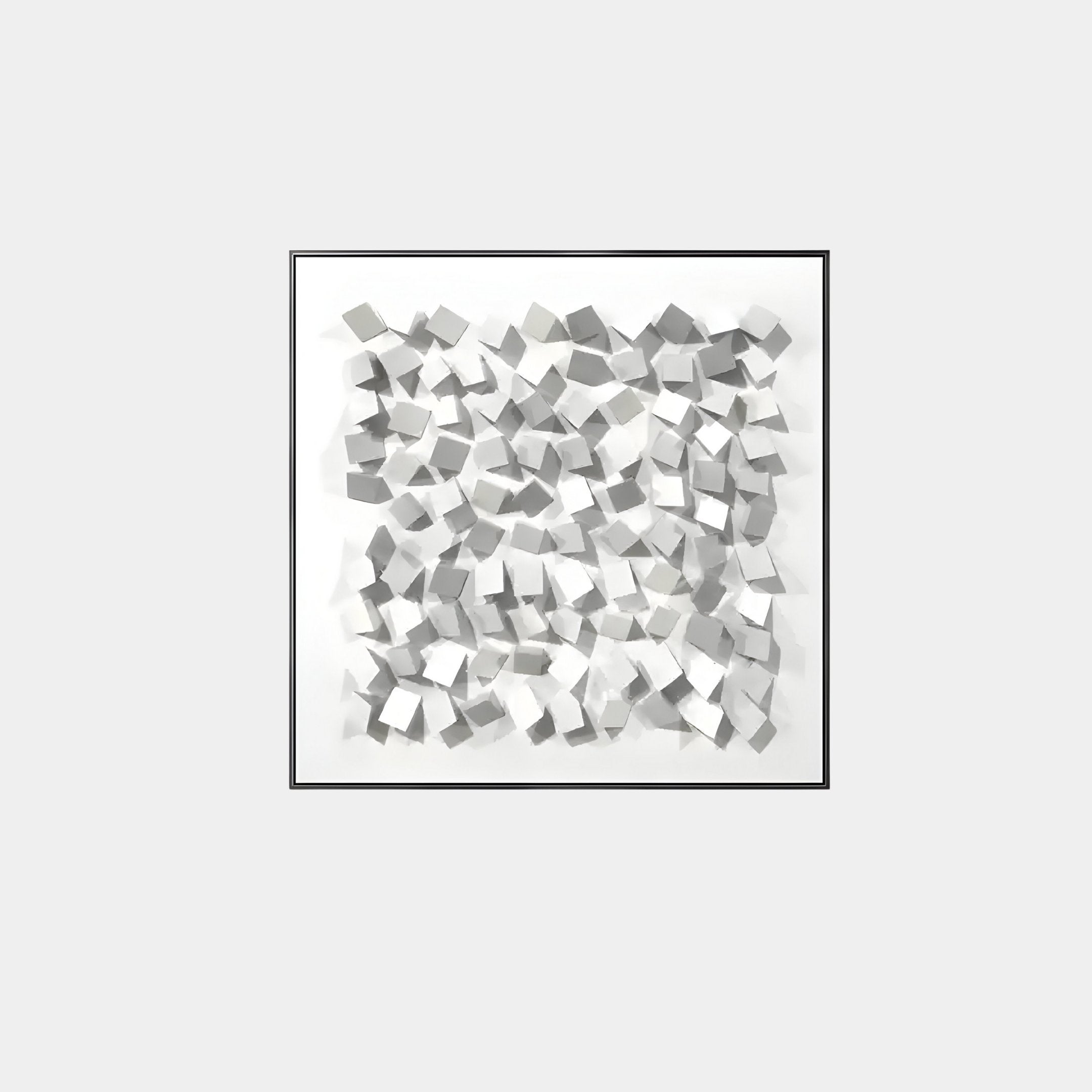 The Cubitara White Abstract Wood Cluster 3D Wall Art by Giant Sculptures features small white cubes artistically scattered in a square frame. The shadows add depth, enhancing the geometric design to create an intriguing abstract piece against a plain gray background.