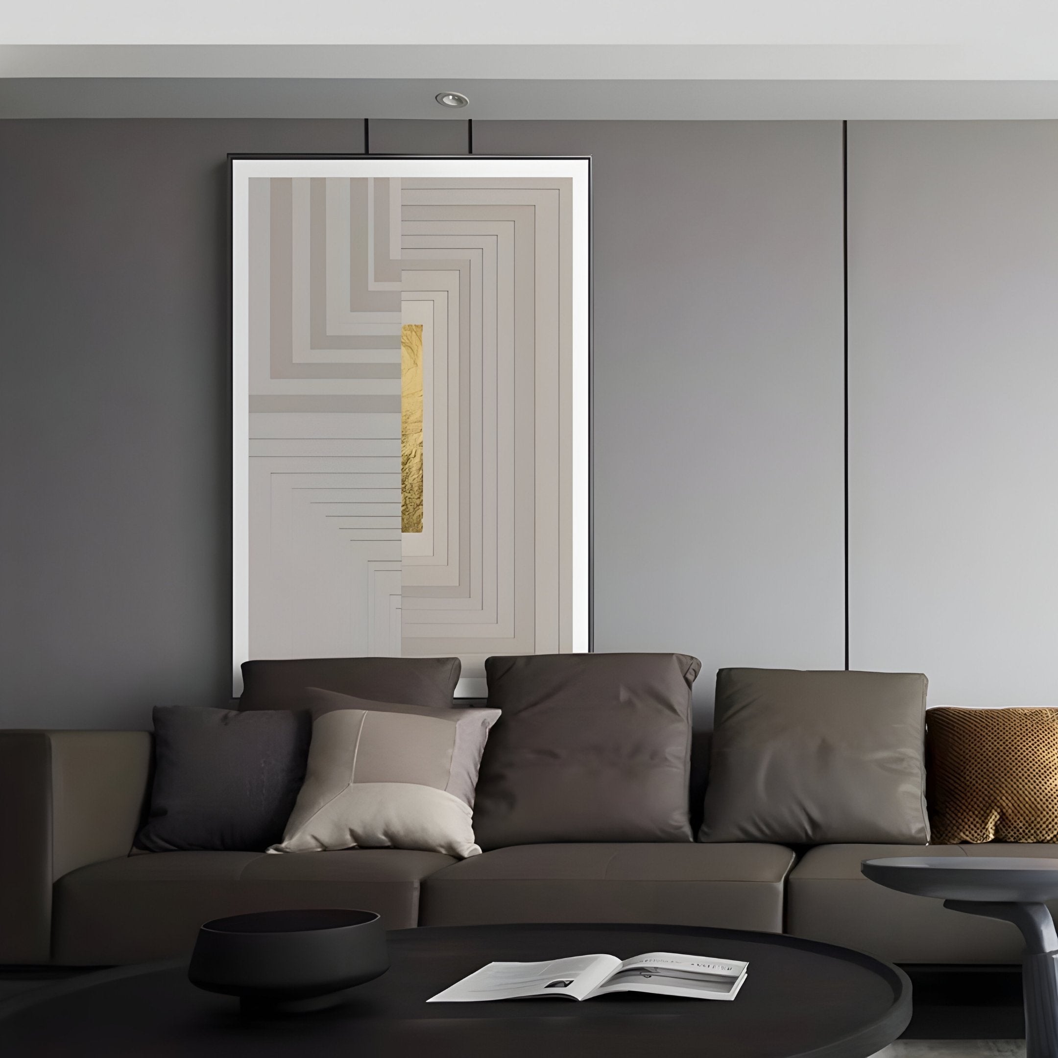 A modern living room showcases a gray sofa with cushions, highlighted by the Giant Sculptures Striato Dove Grey 3D Wooden Wall Art with Gold Accent above it. A round black coffee table sits in front, holding an open magazine, all exuding minimalist style and sophisticated decor.