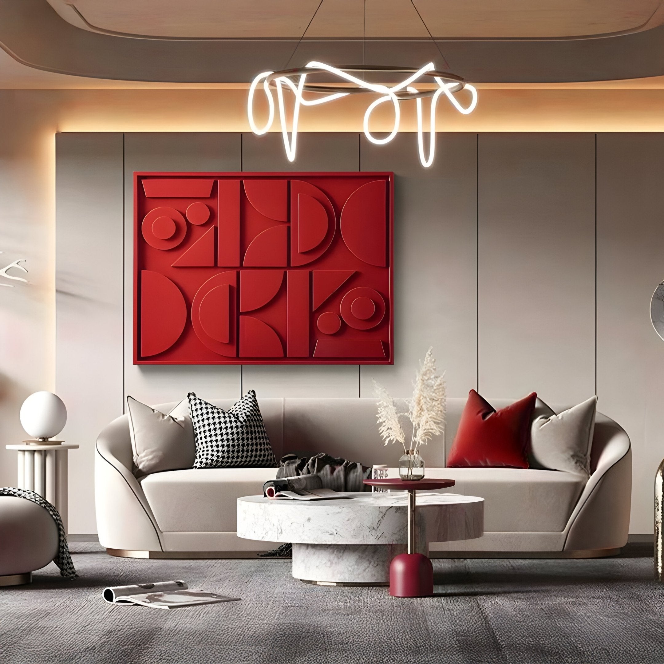 A modern living room features a beige sofa with red and black pillows. The Formate Vibrant Red Geometric Wood Painted 3D Wall Art by Giant Sculptures adds depth on the wall. A round marble coffee table with vases on a gray rug, while a wavy light fixture illuminates from above.