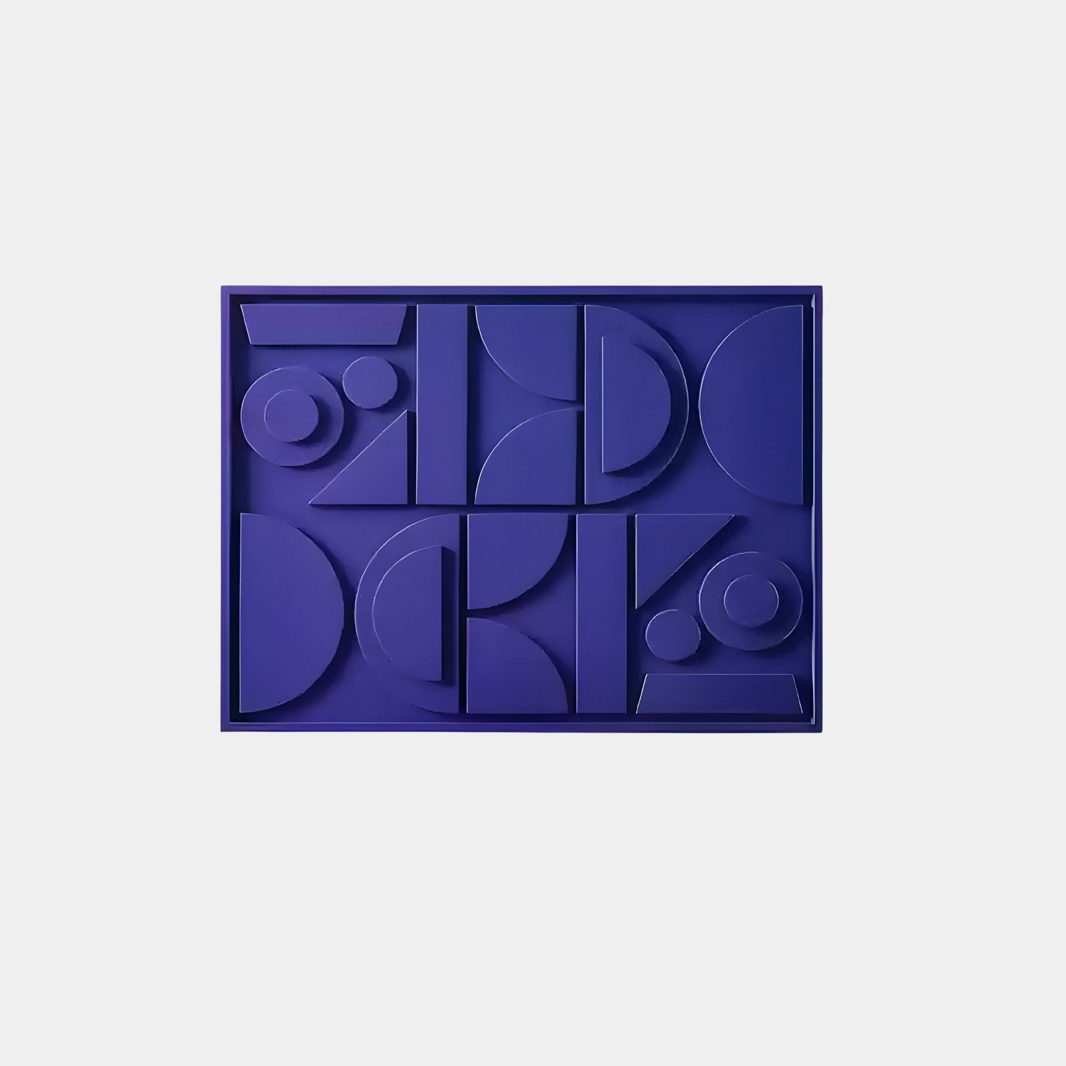 The Giant Sculptures Formate Royal Purple Geometric Wood Painted 3D Wall Art showcases circles, semicircles, triangles, and rectangles in shades of blue with royal purple accents on a light gray background.