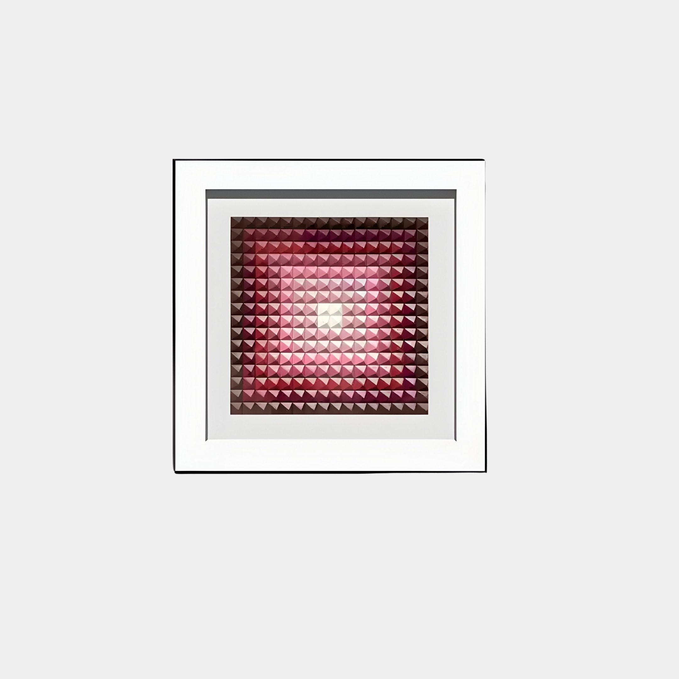 The Viretta Red Gradient Pyramid Textured 3D Wooden Wall Art by Giant Sculptures features pink and red triangles radiating from a central point, creating a light to dark gradient effect. Its white frame enhances its striking appeal against a simple backdrop.